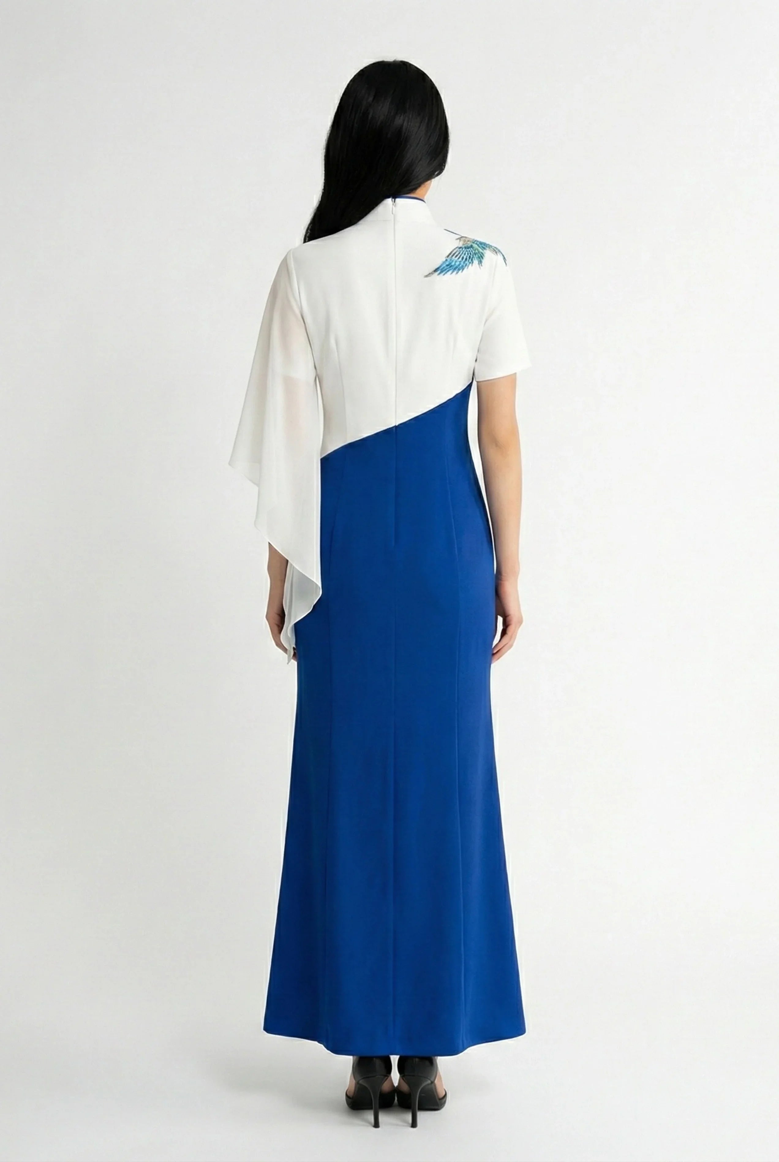 Back view of a modern asymmetrical blue and white qipao-style gown