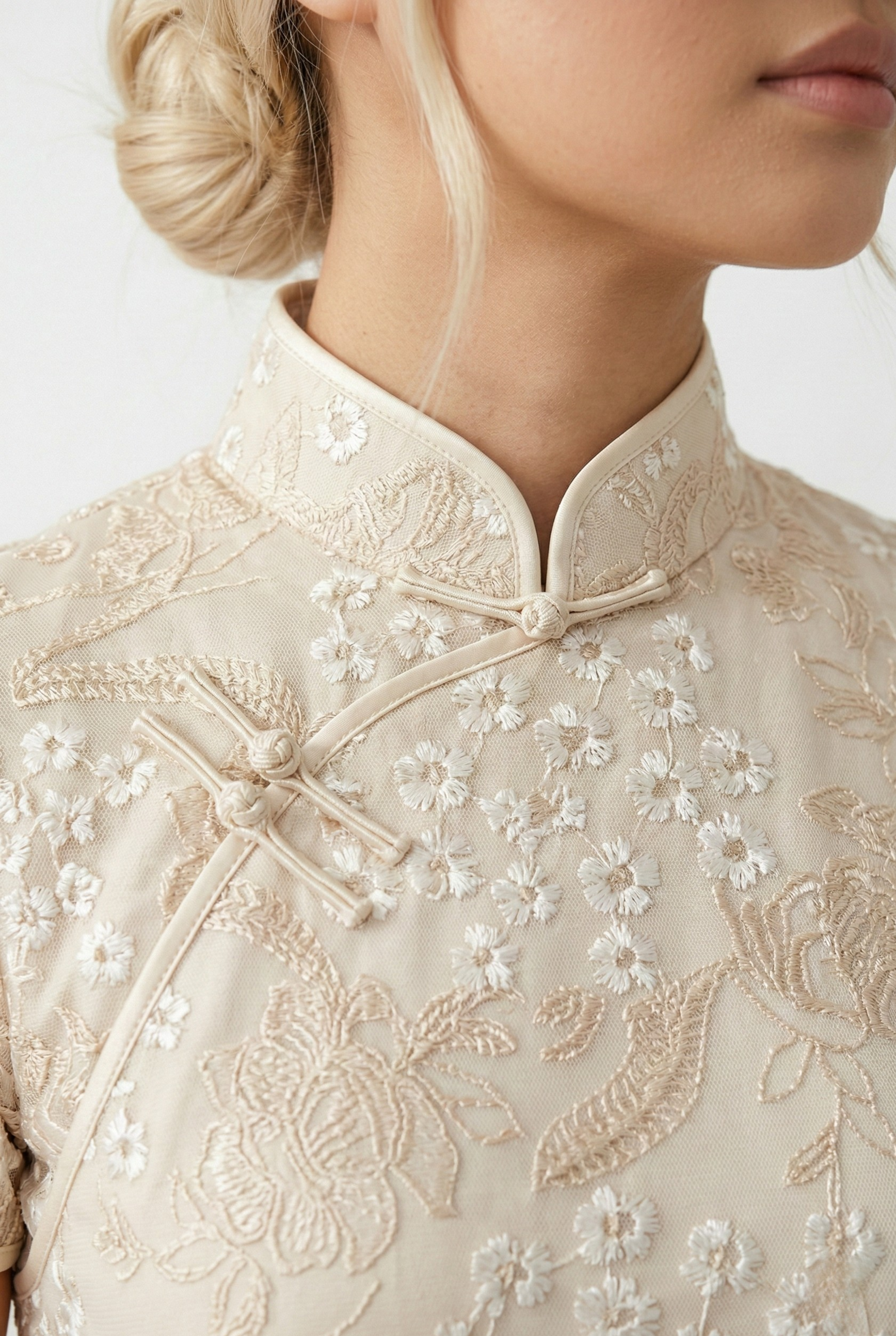 Beige qipao detail, mandarin collar and white floral embroidery
