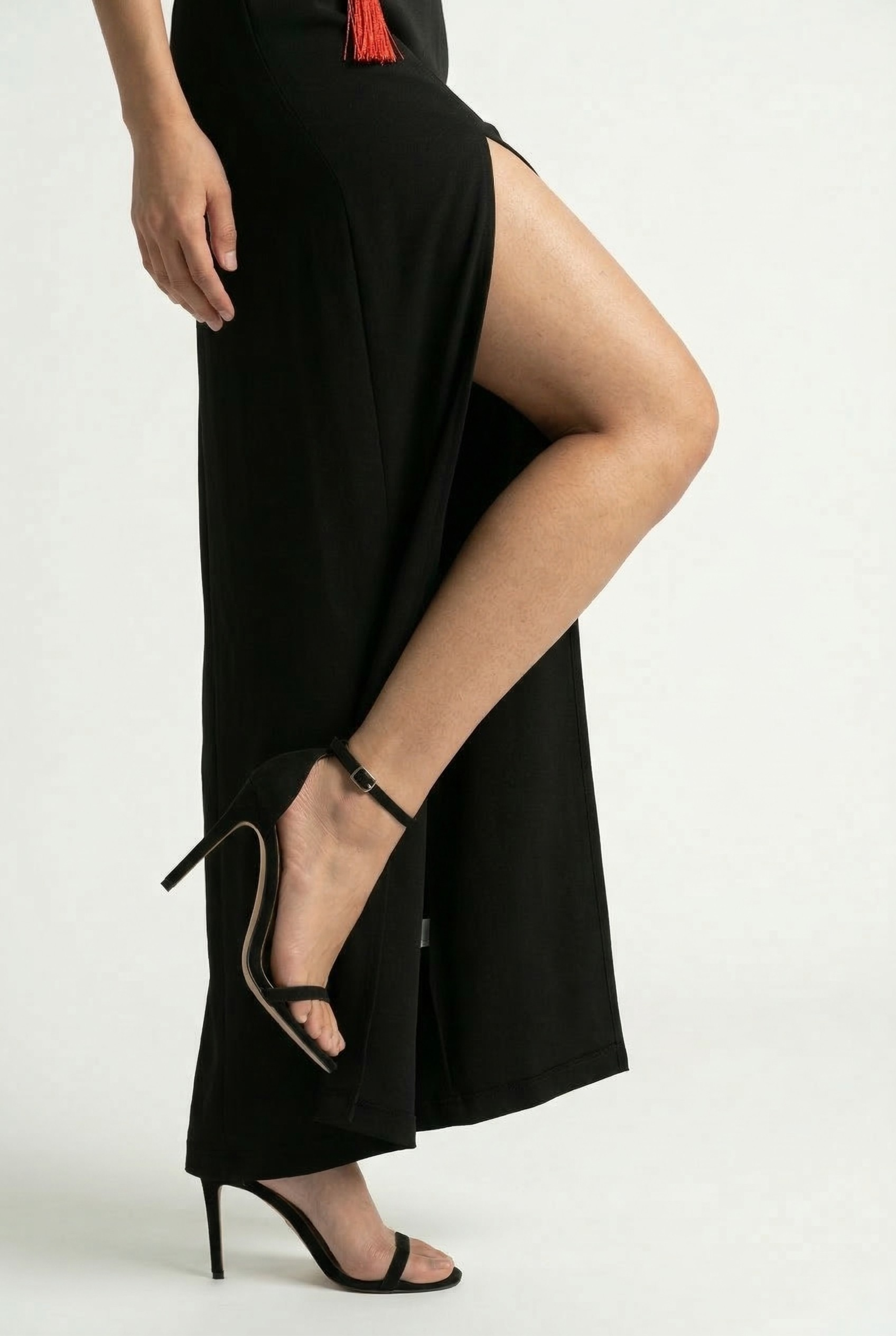 Detailed shot of the high side slit on a long black Cheongsam dress.