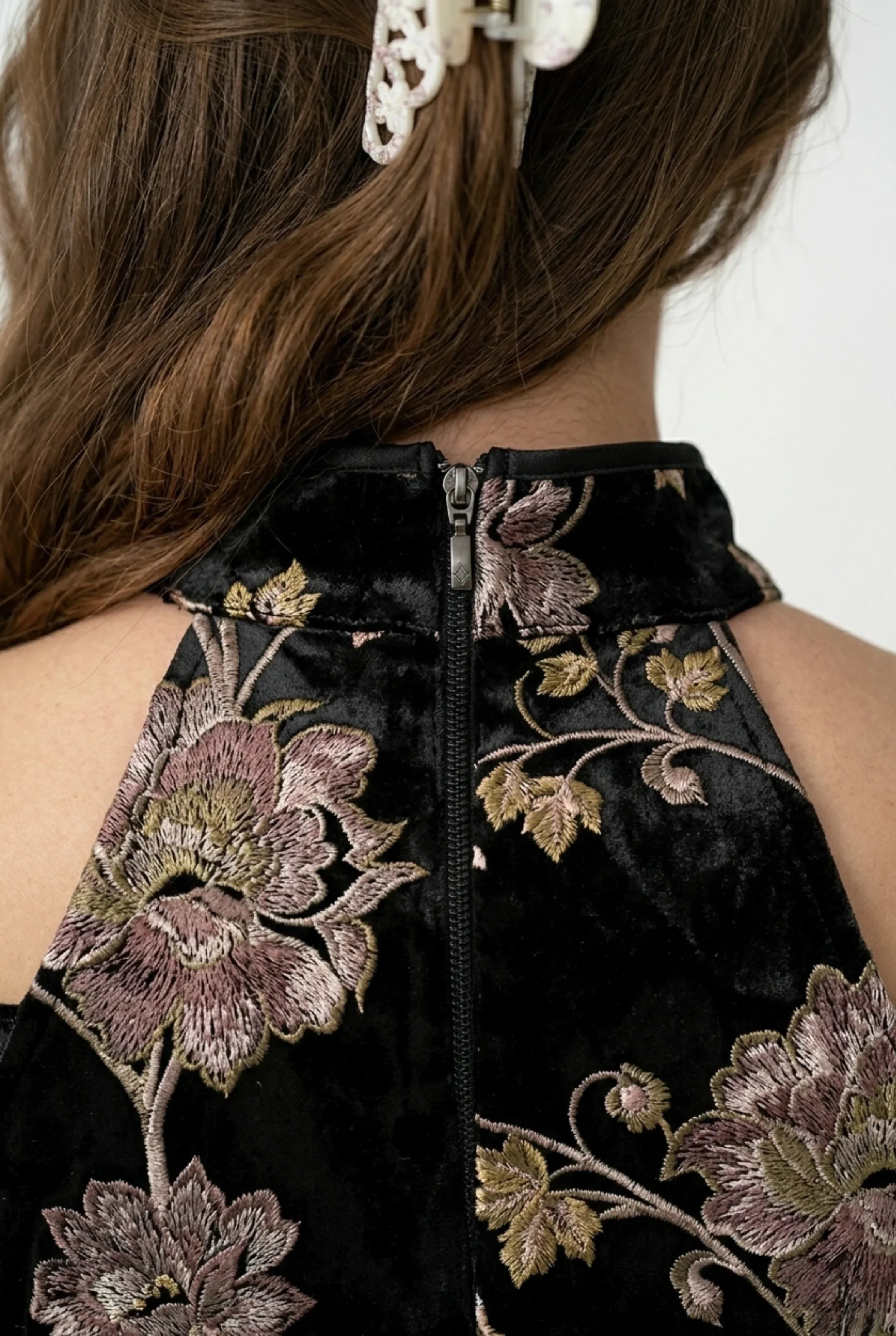 Detail of back collar and zipper closure on a black floral cheongsam