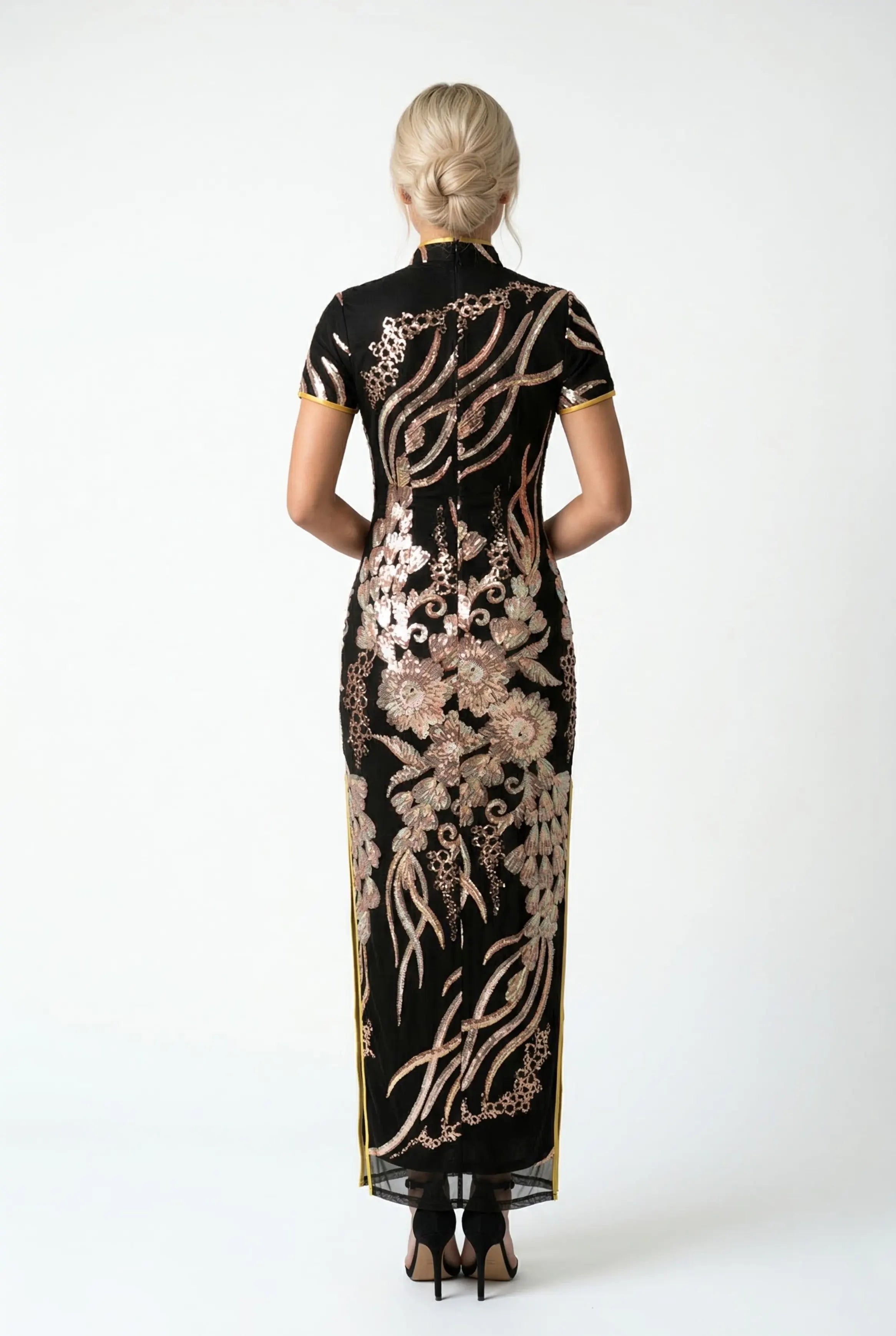 Back view of a floor-length black Cheongsam featuring flowing gold sequin patterns and a high mandarin collar.