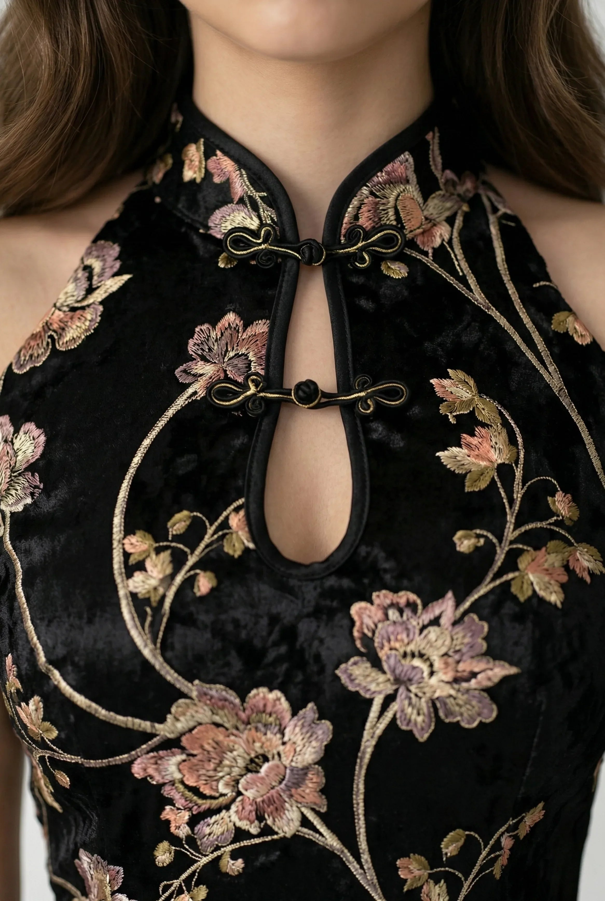 Close-up of mandarin collar and keyhole neckline on black floral qipao