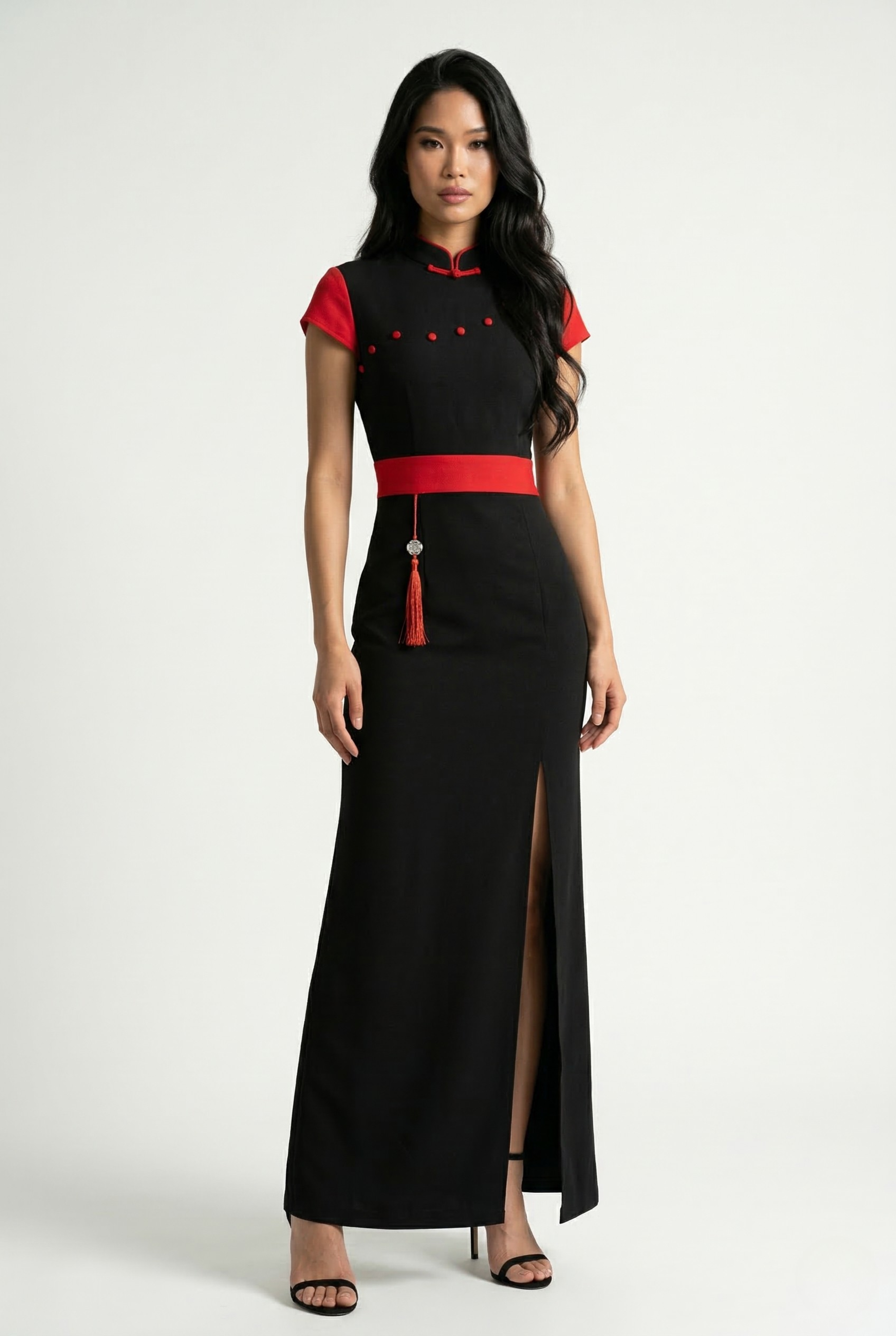 Full-length front view of a long black Qipao dress with red cap sleeves and a red waist belt.