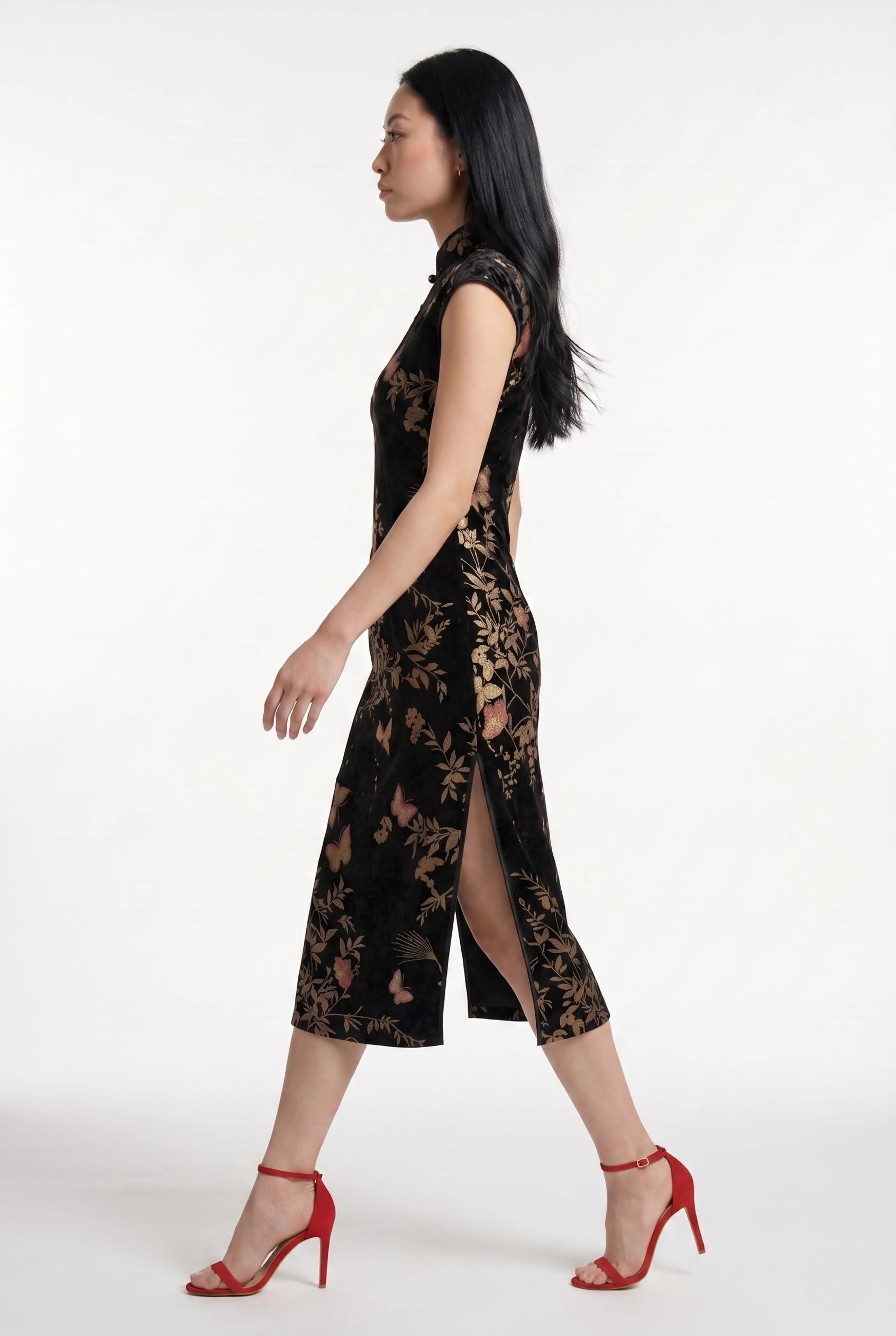 Close-up back view showing the hidden zipper and high collar of the black velvet cheongsam