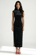 Front view of a sleeveless black velvet cheongsam dress with a high mandarin collar and red strappy heels