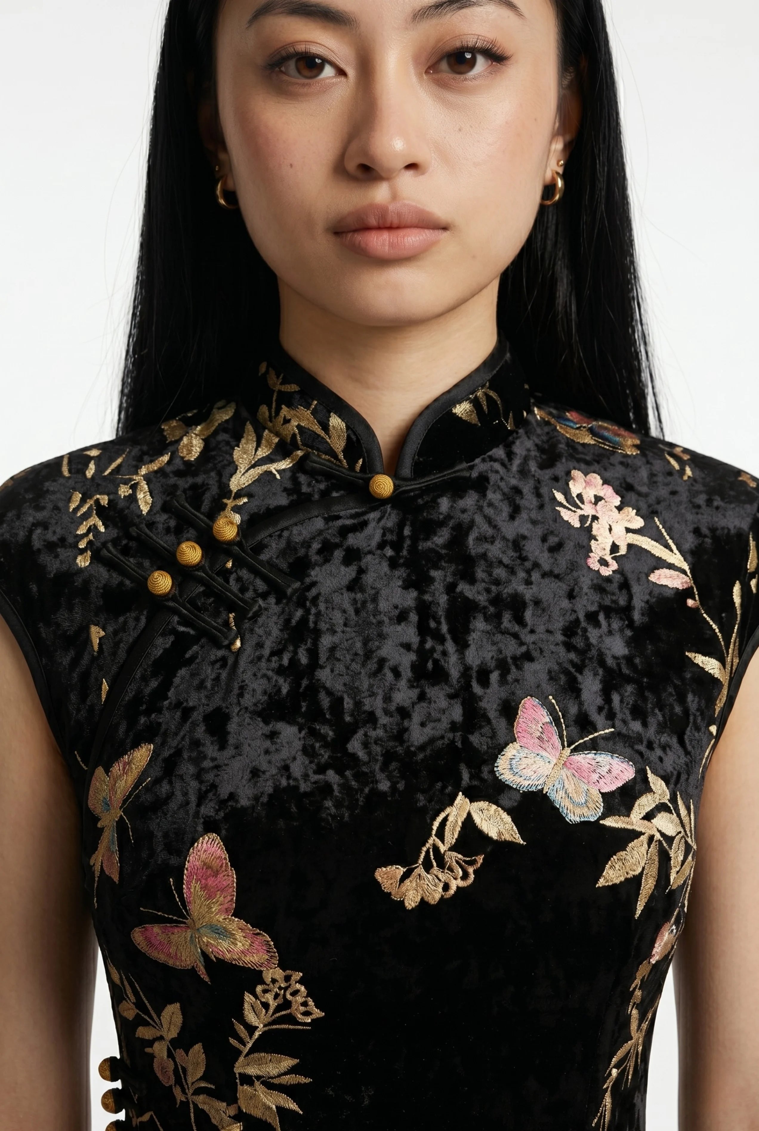 Full-body side profile view of a woman in stride wearing the black velvet cheongsam