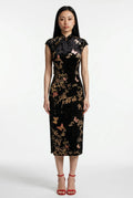 Front full-length view of a sleeveless black velvet Chinese dress with a mandarin collar