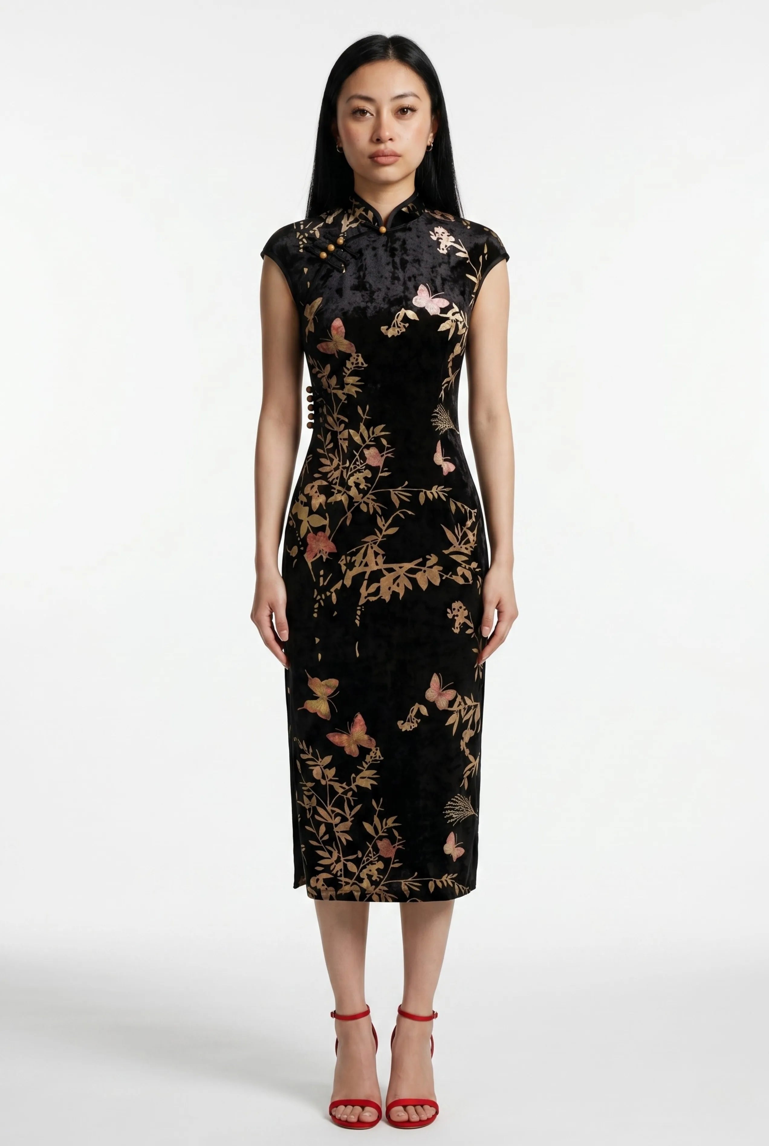 Front full-length view of a sleeveless black velvet Chinese dress with a mandarin collar