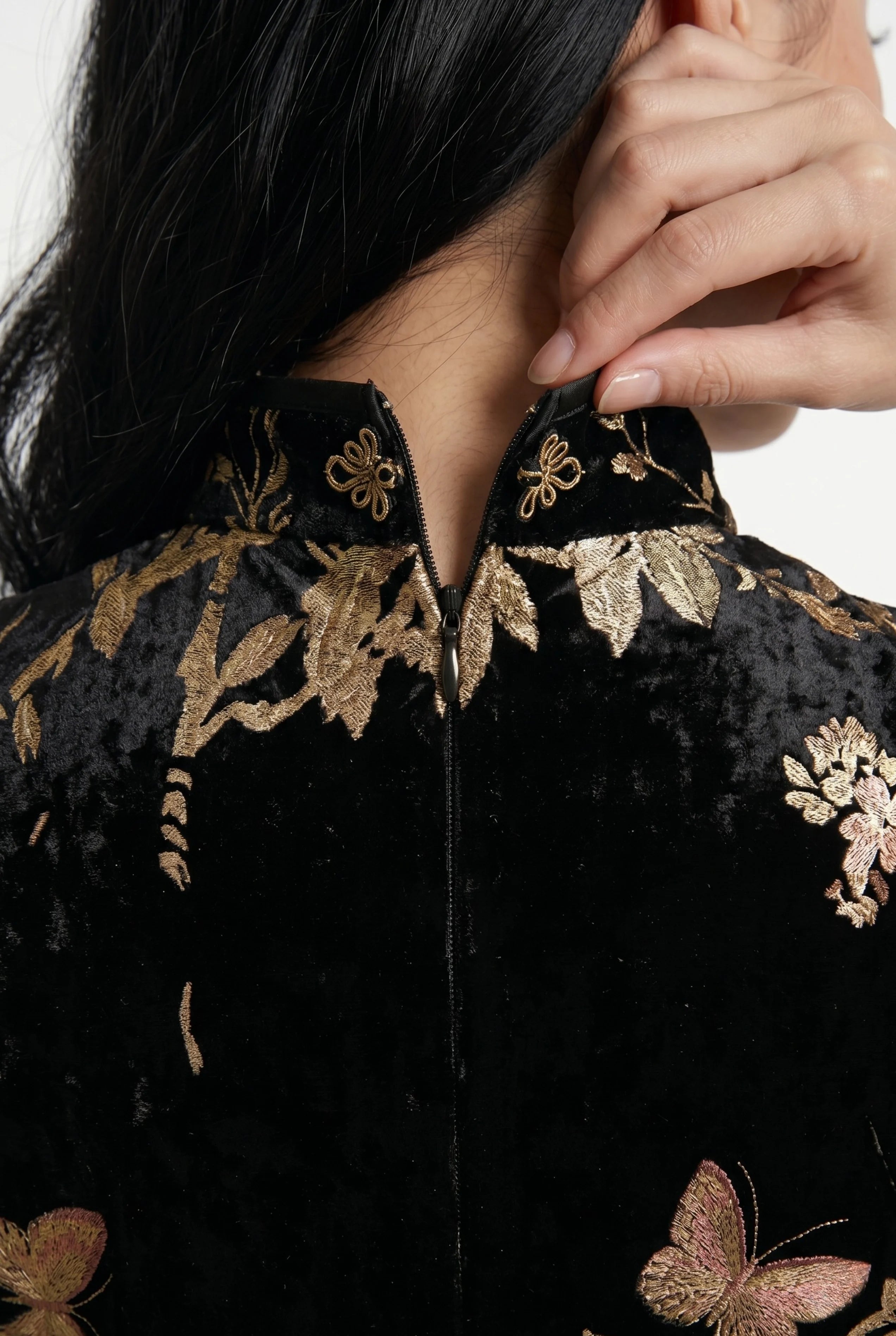 Close-up front view highlighting the keyhole opening, mandarin collar, and toggle button of the black velvet dress