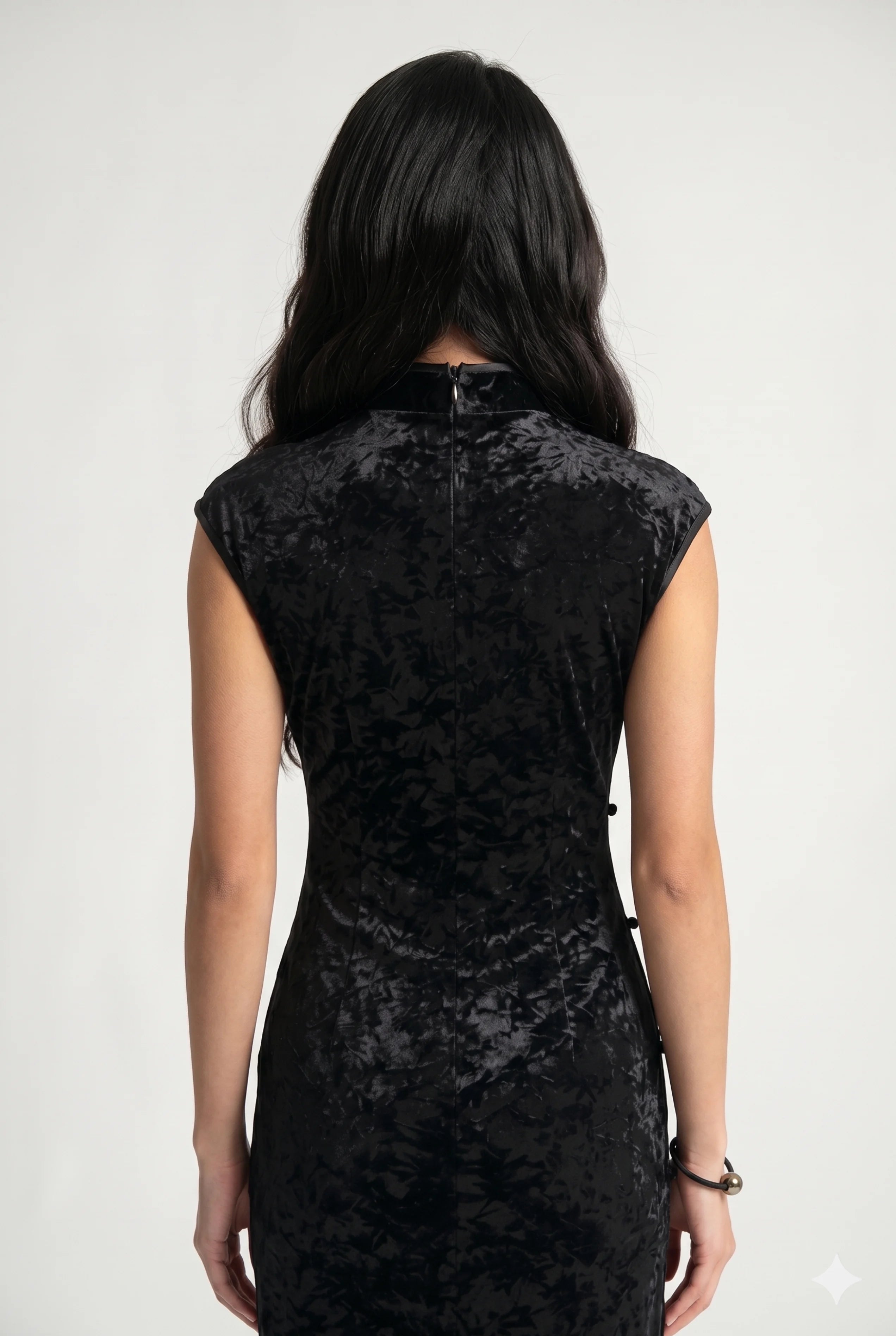 Close-up back view showing the high collar structure, clean zipper closure, and shimmering crushed velvet fabric.