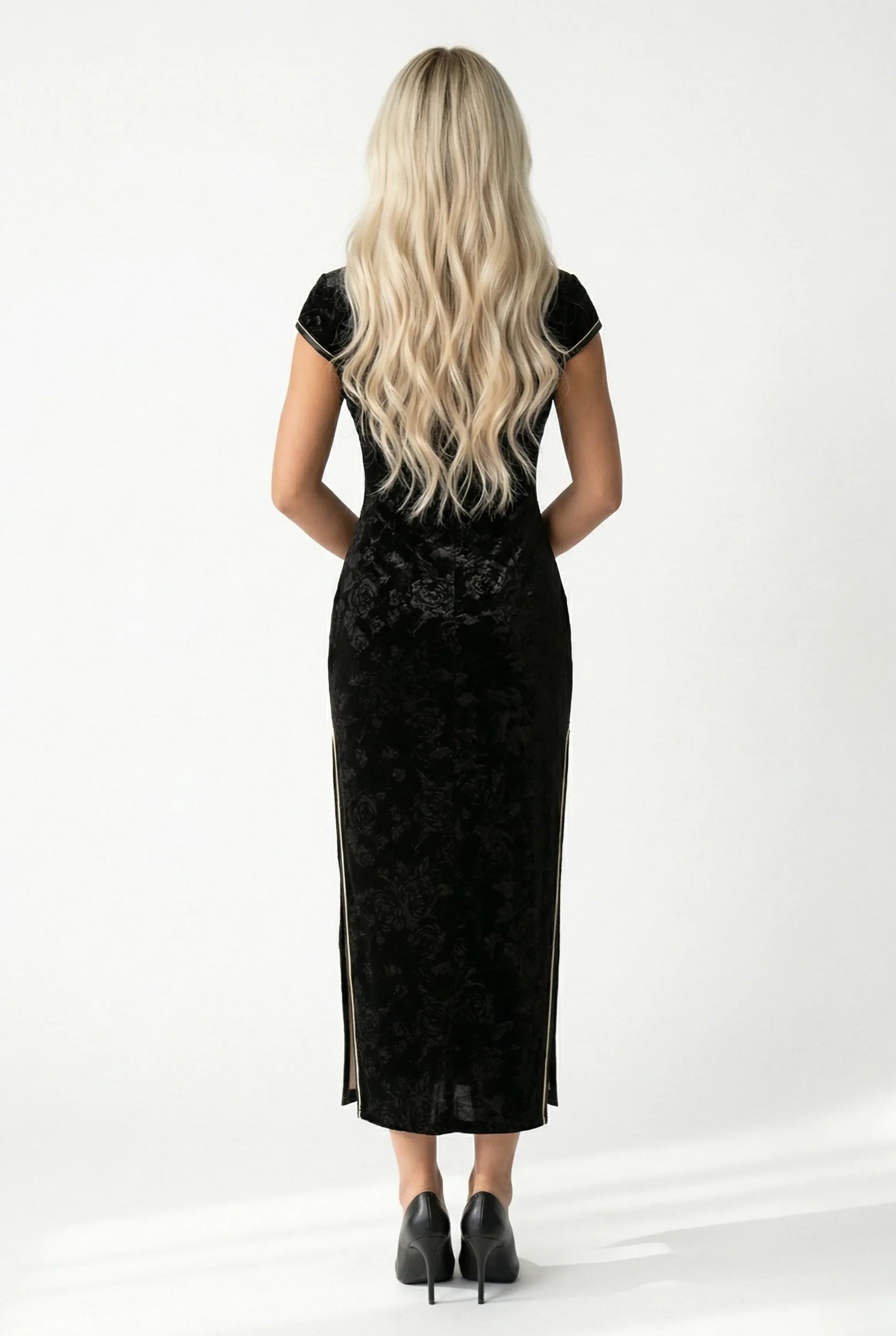 Back view of the long black velvet qipao showing the slim fit.