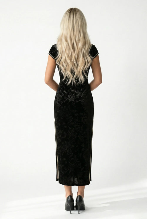 Back view of the long black velvet qipao showing the slim fit.