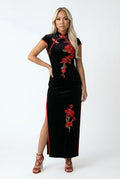 Full-length front view of a black velvet Qipao with red floral embroidery and red piping.