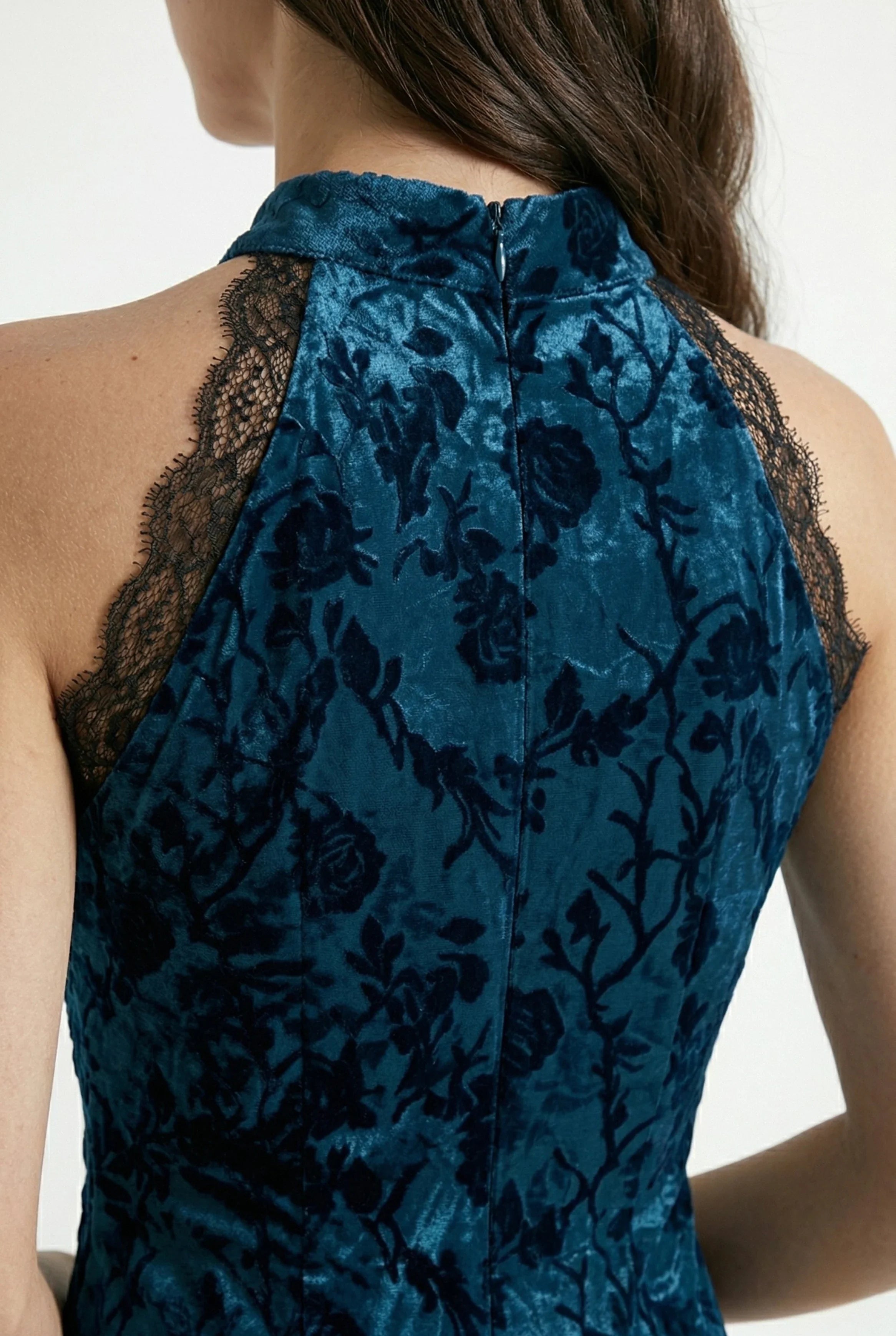 Detail view of the back collar and lace shoulder trim of the cheongsam.