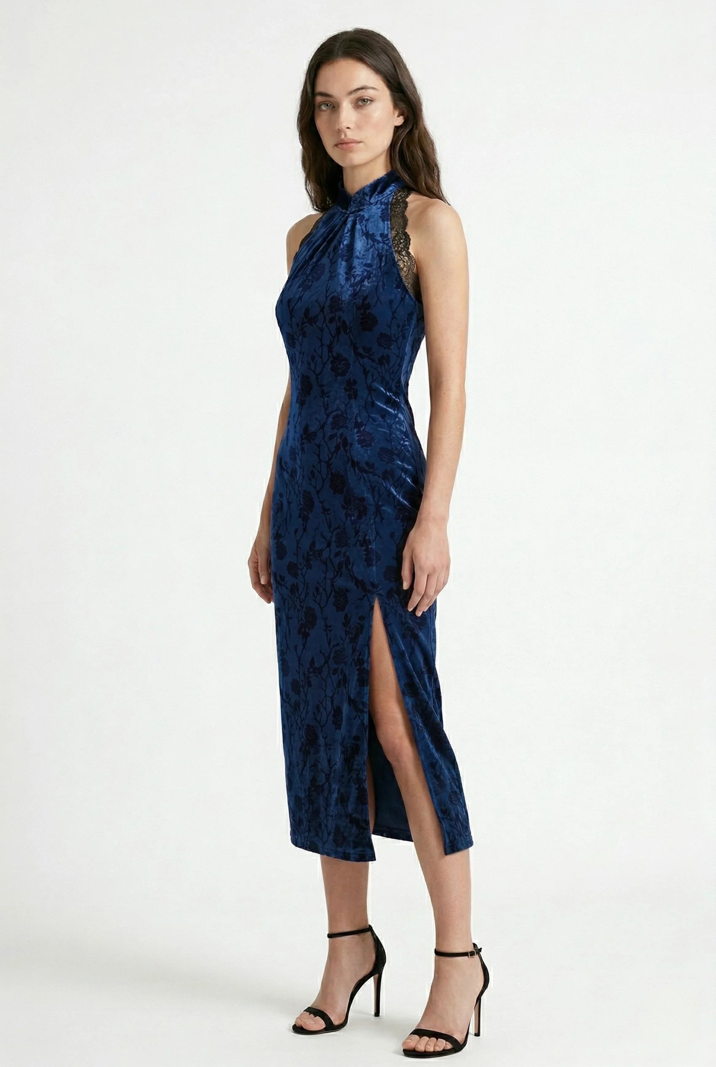 Side view of a blue velvet Chinese dress featuring a high leg slit.
