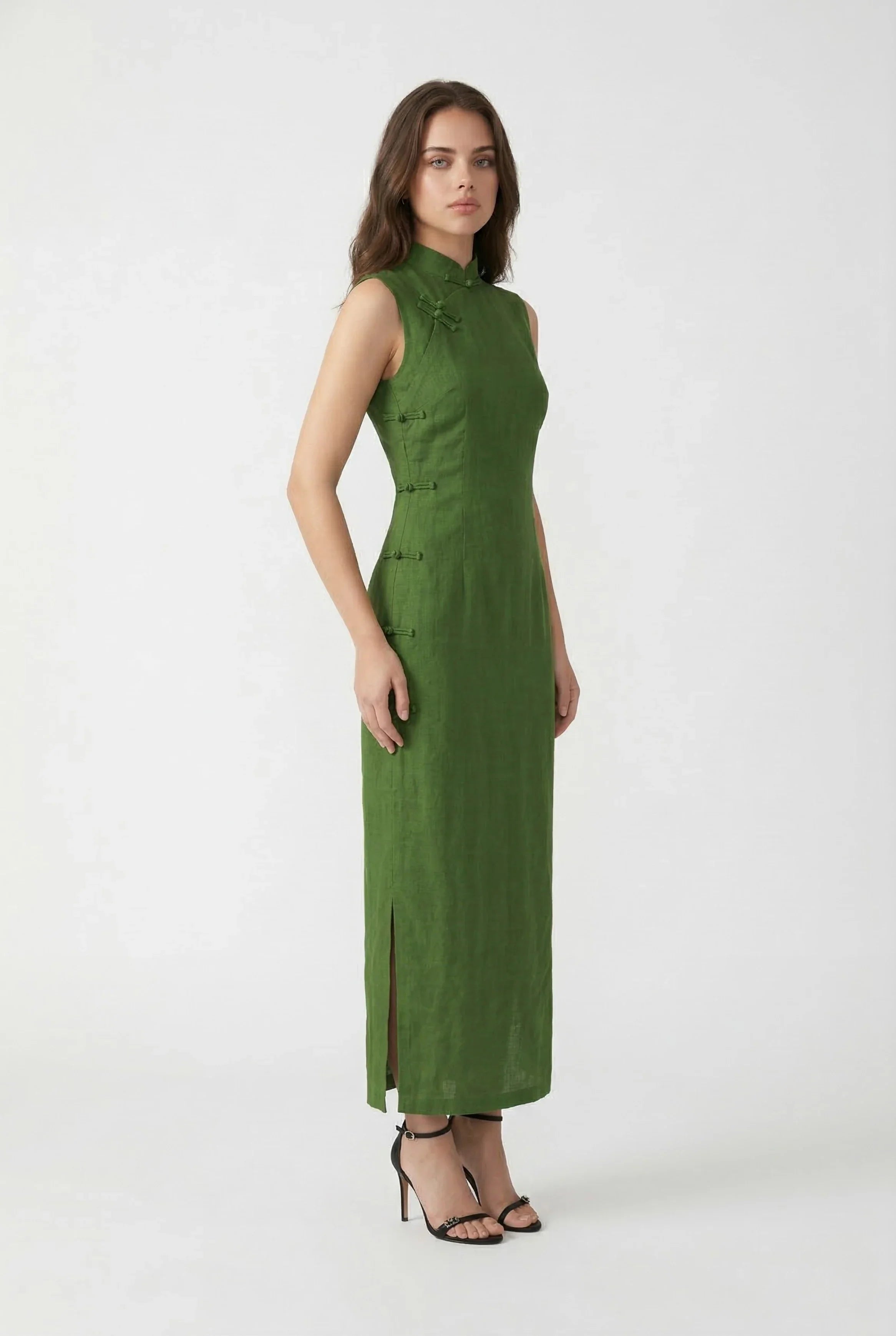 Side profile of a casual green Chinese dress showing the relaxed form-fitting fit and sleeveless design.