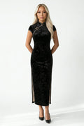 Front view of a black velvet cheongsam with a subtle floral pattern.