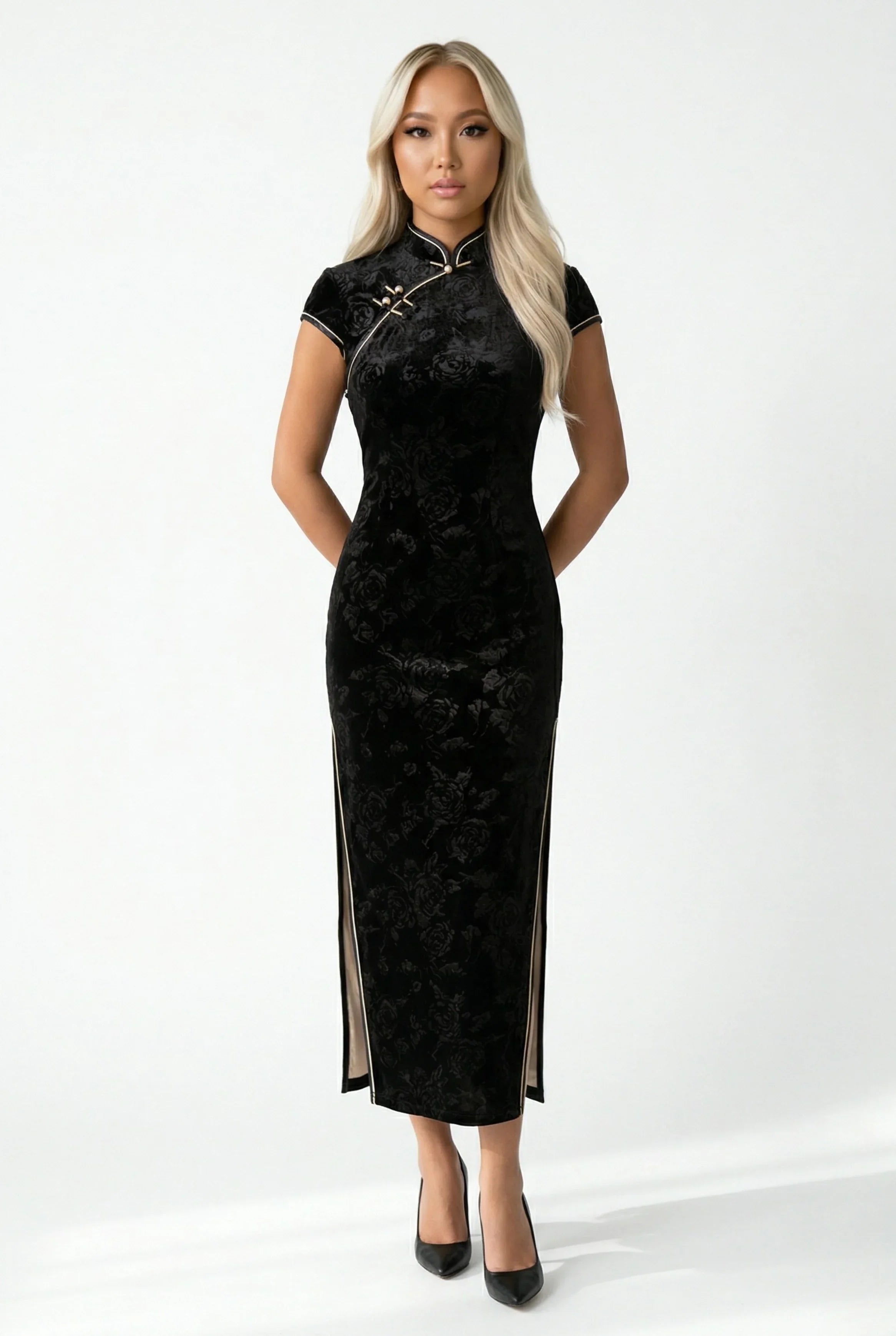Front view of a black velvet cheongsam with a subtle floral pattern.