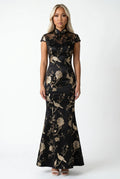 Front full-length view of a long black cheongsam dress with gold floral embroidery and cap sleeves