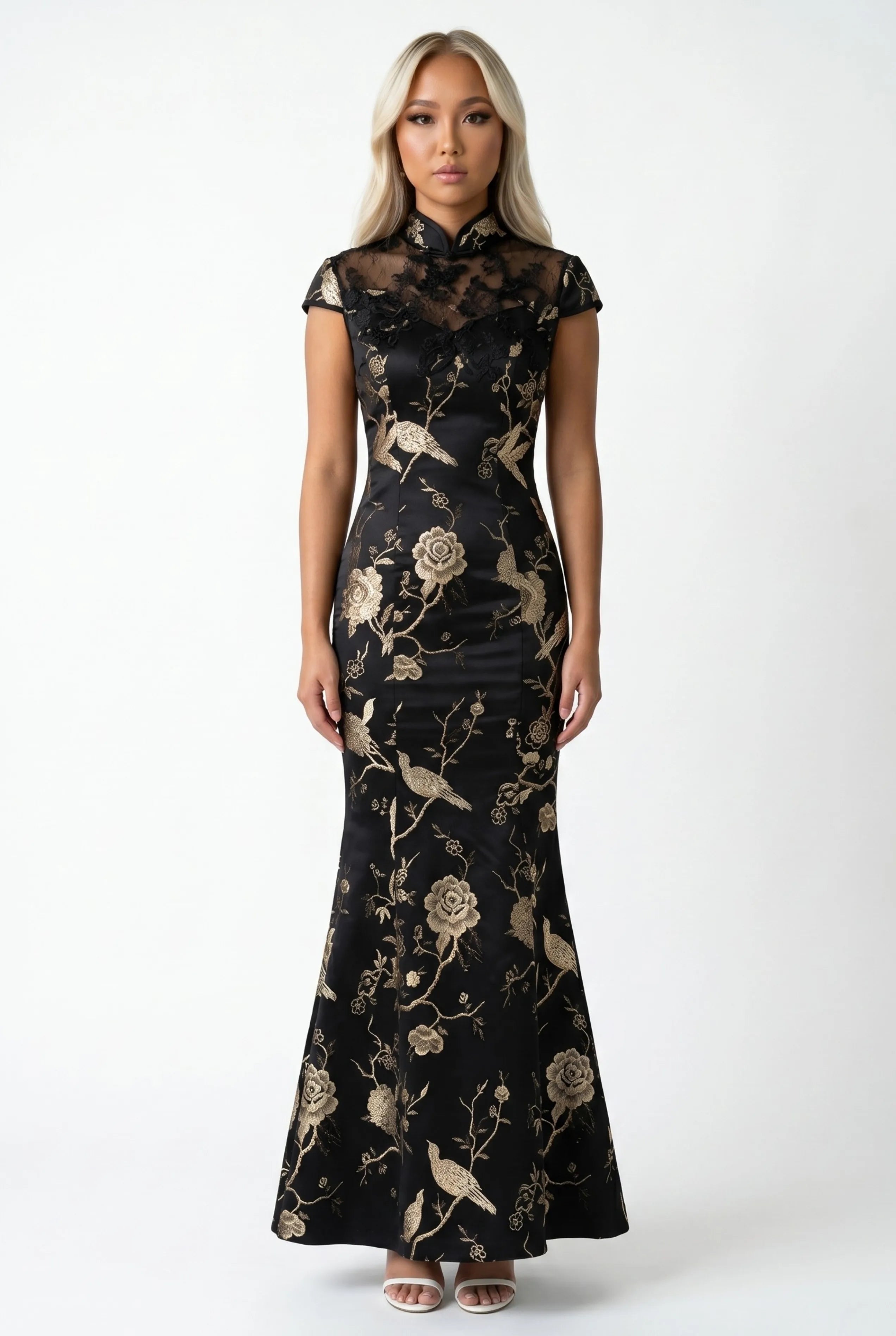 Front full-length view of a long black cheongsam dress with gold floral embroidery and cap sleeves