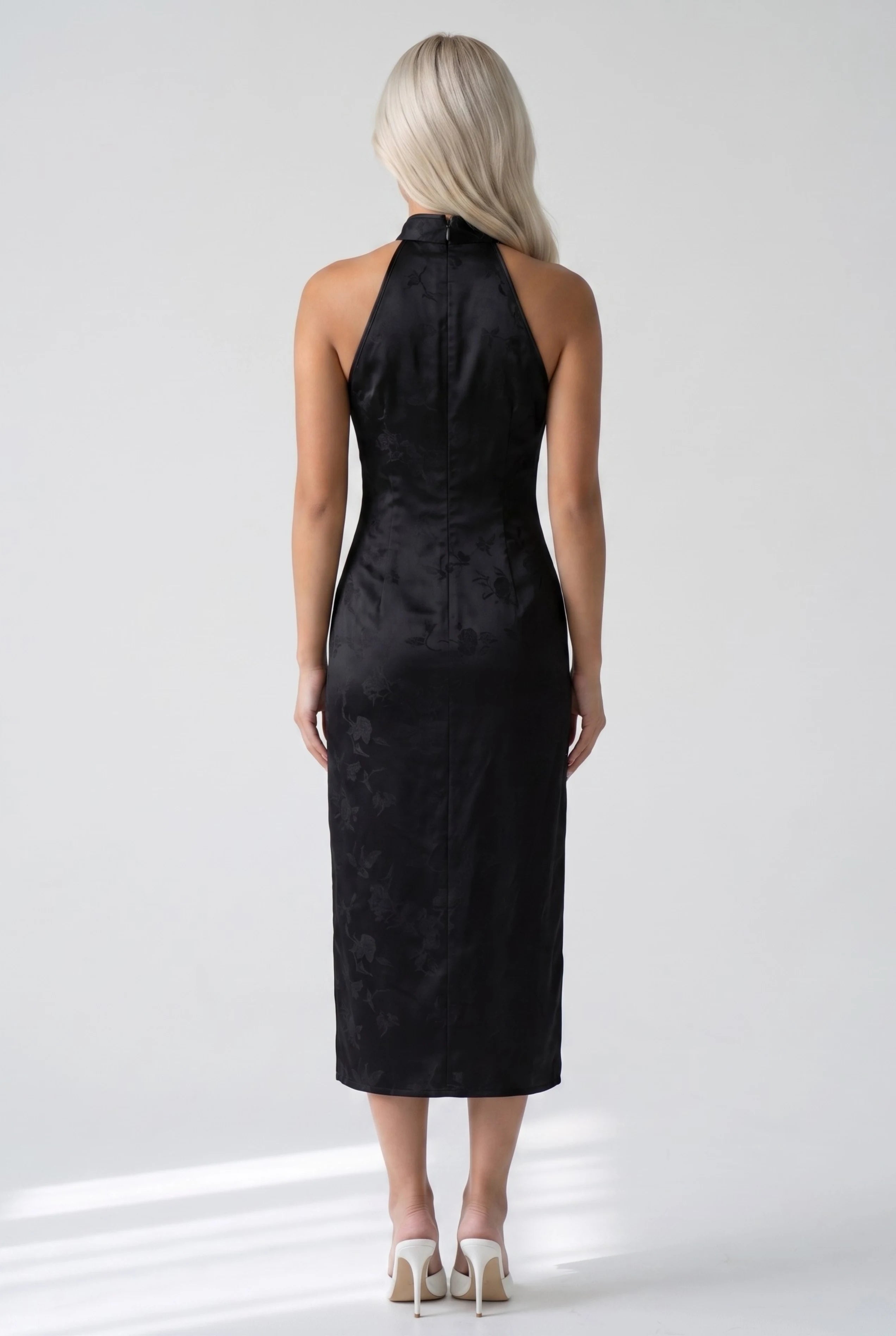 Full-length back view of the black floral pattern cheongsam dress showing the halter cut and midi silhouette