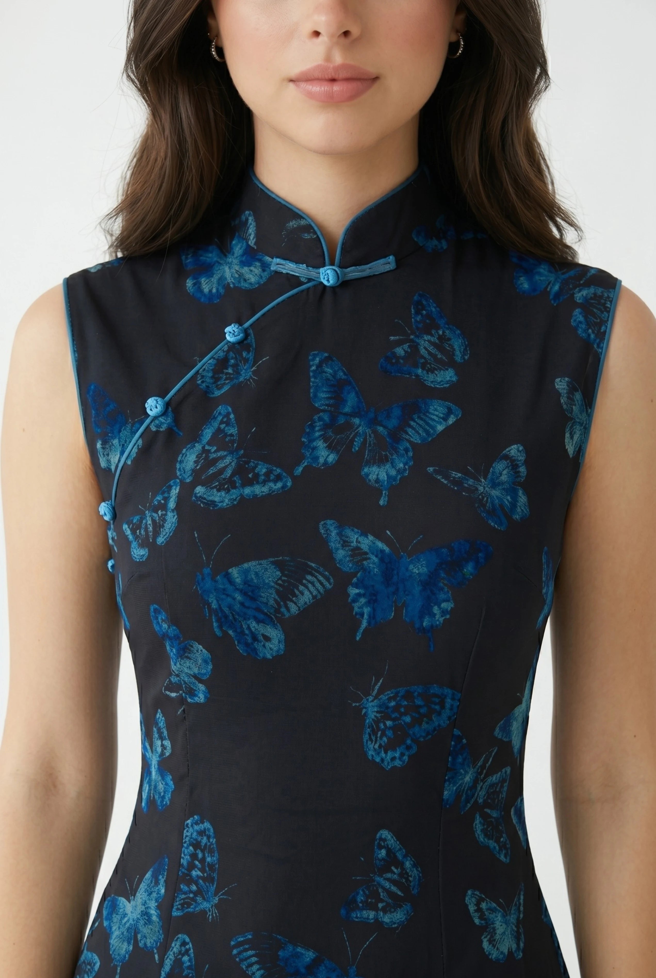 Close-up front view highlighting the high mandarin collar and subtle butterfly pattern woven into the light green fabric