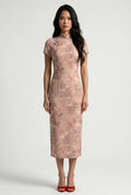 Front full-length view of a cap-sleeve pastel pink Chinese dress with a delicate floral and branch pattern, paired with red heels