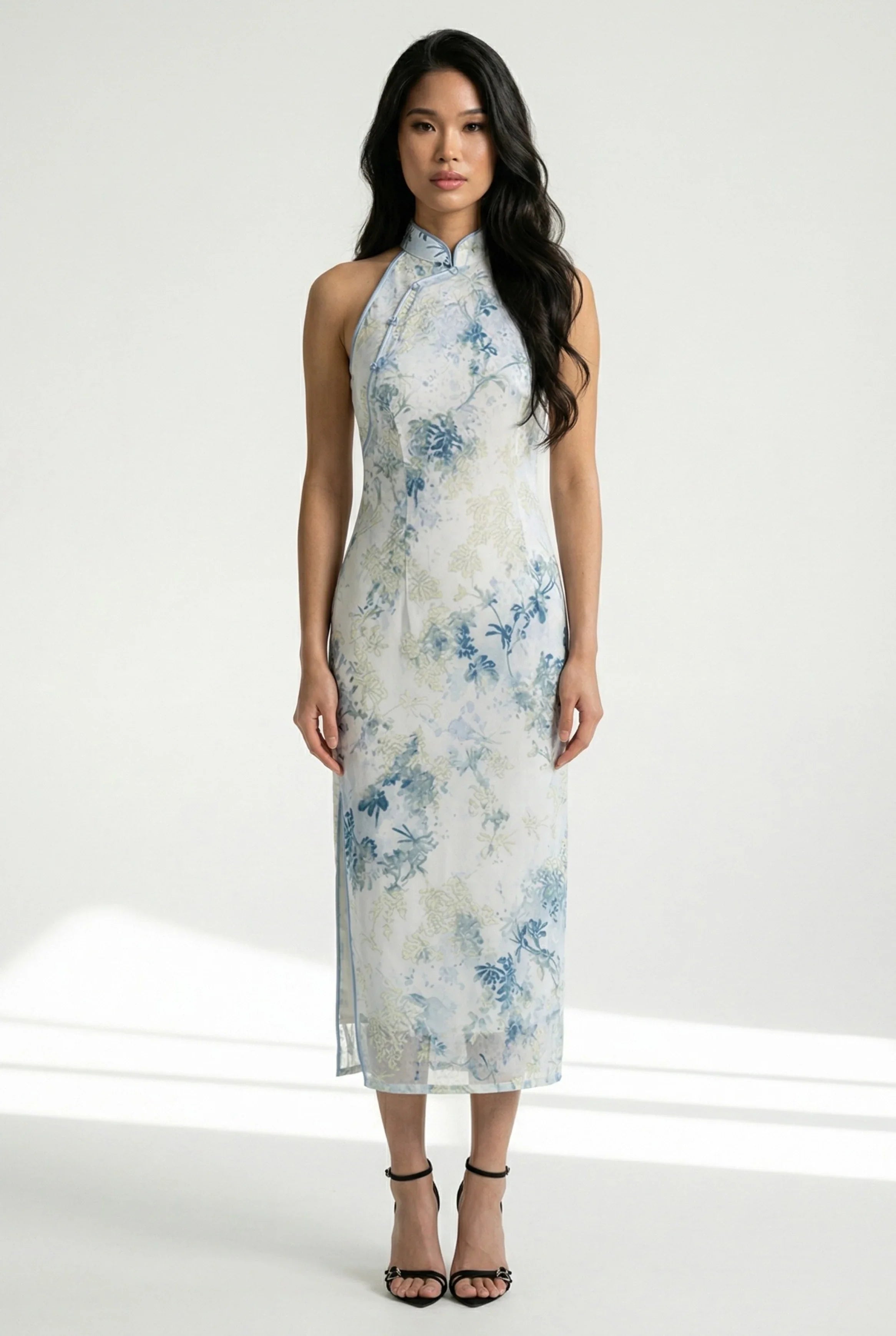 Front view of a sleeveless chinese floral pattern dress in blue and white.