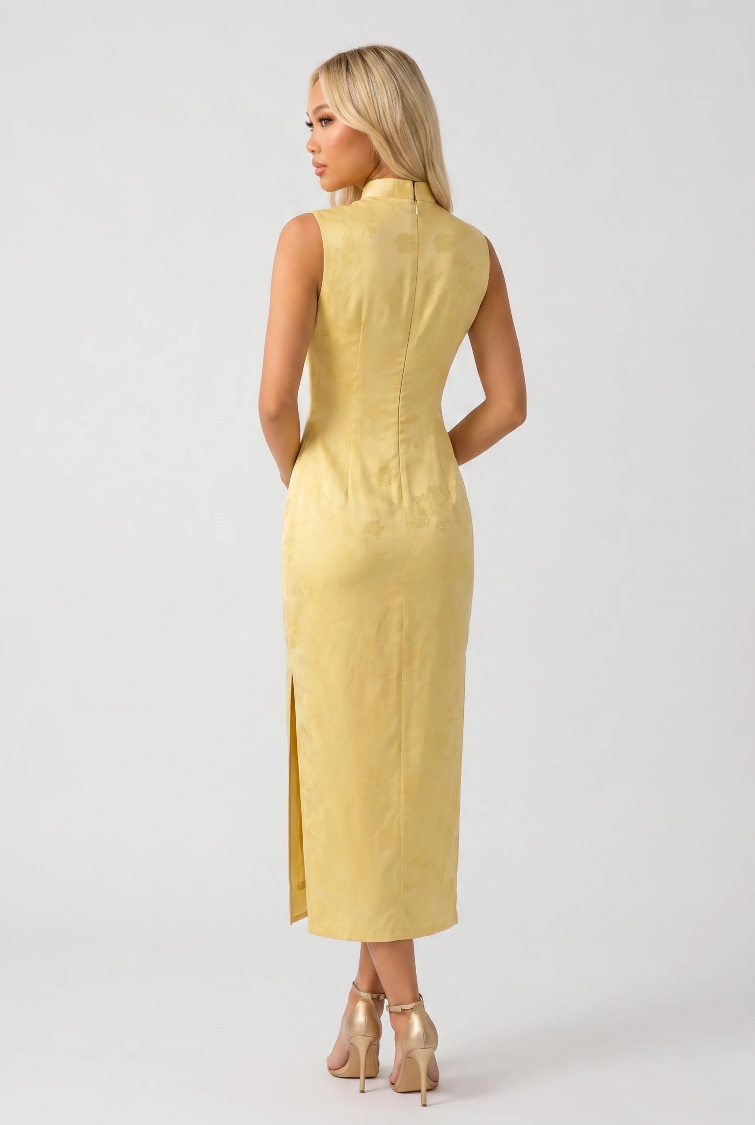 Full-length back view of the sleeveless yellow Chinese qipao showing the tailored midi silhouette