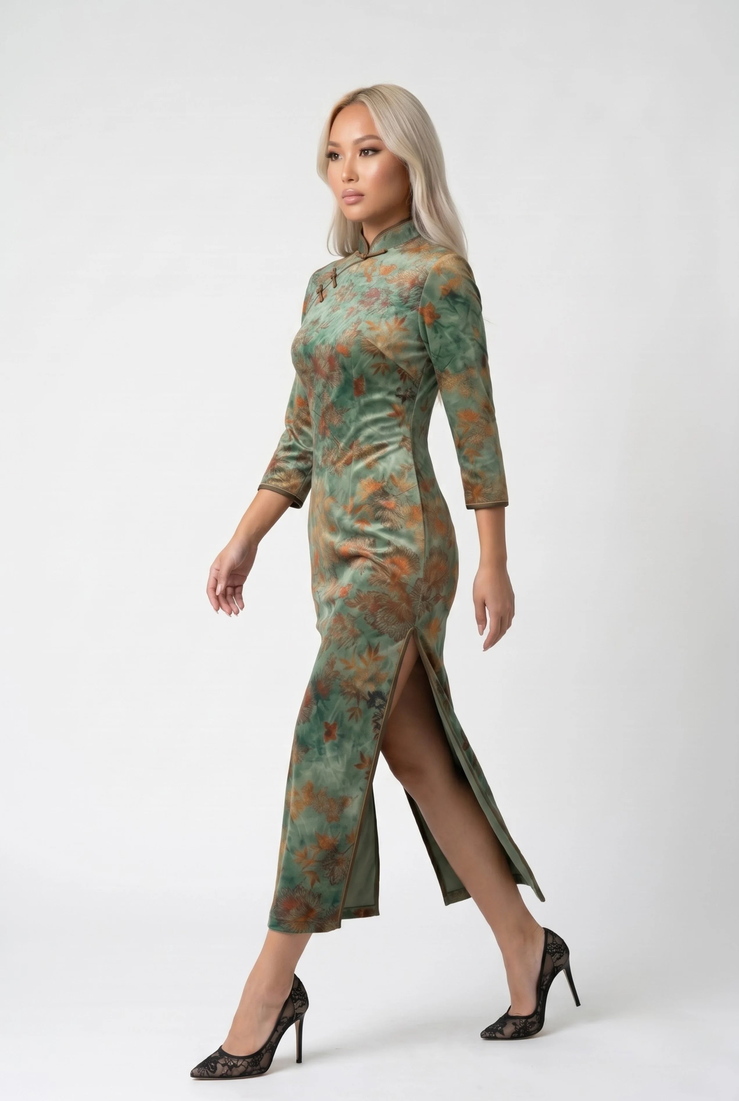 Side profile view of a woman walking in the vintage green qipao dress, showcasing the high side slit