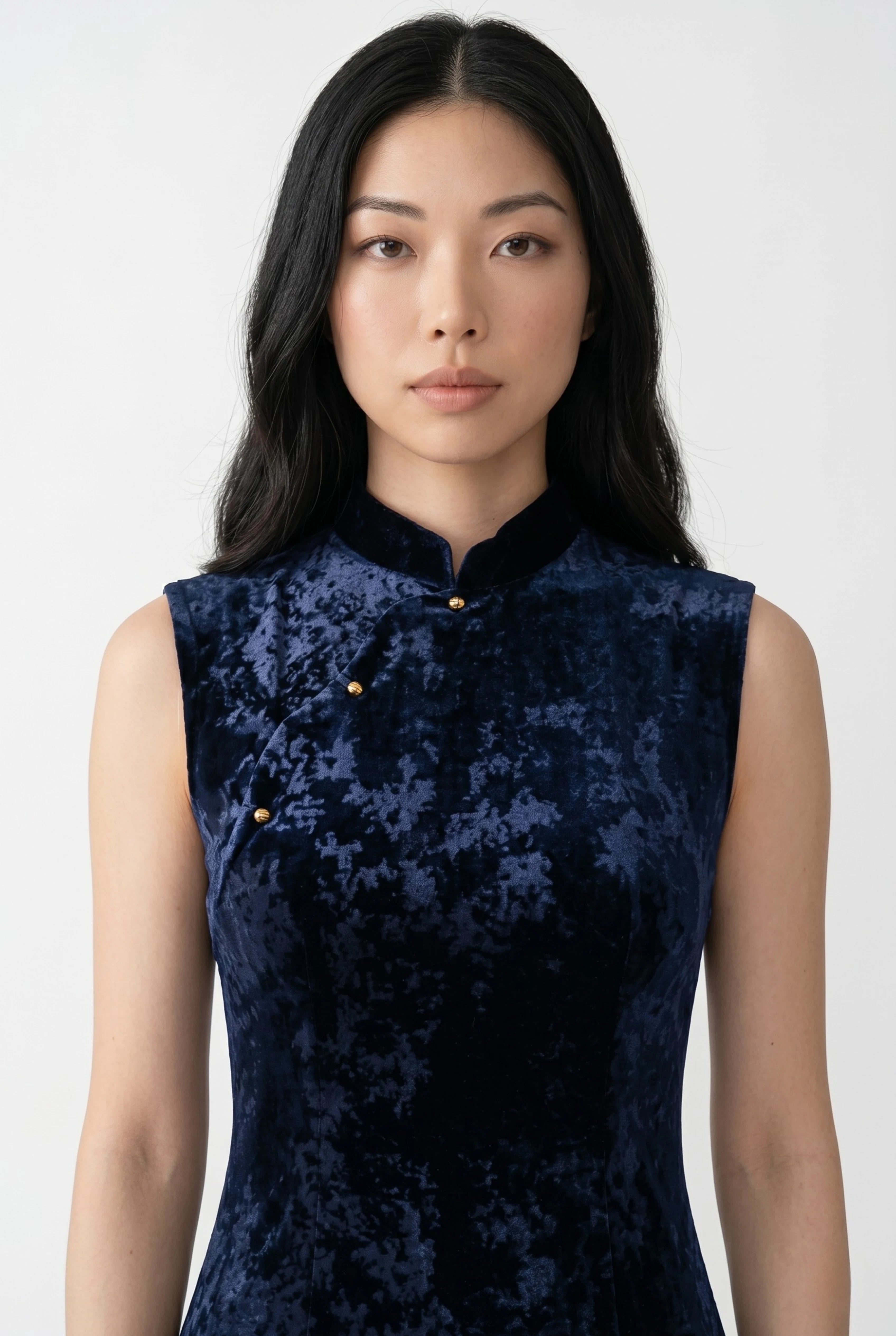 Close-up front view highlighting the high mandarin collar and delicate gold button accents on the dark blue bodice