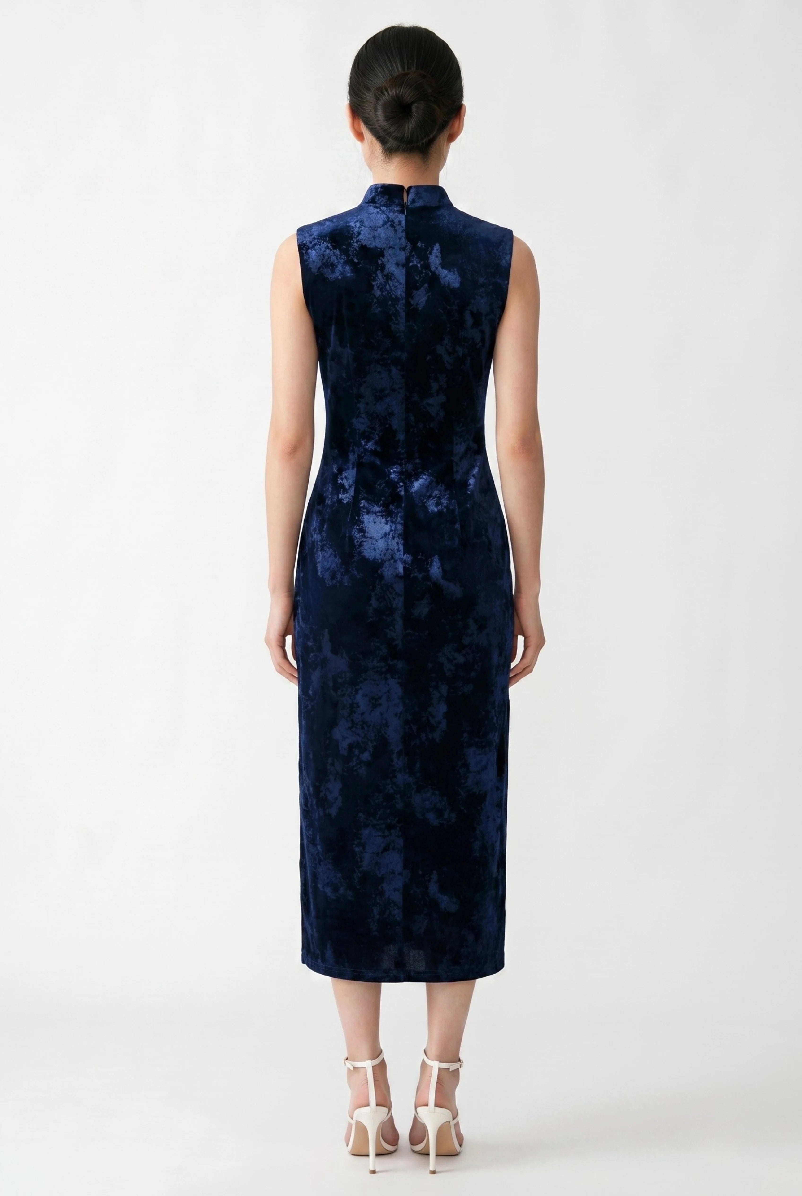 Back view of the sleeveless dark blue velvet cheongsam showing the tailored midi-length fit