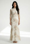 Front full view of a beige Chinese dress with floral embroidery.