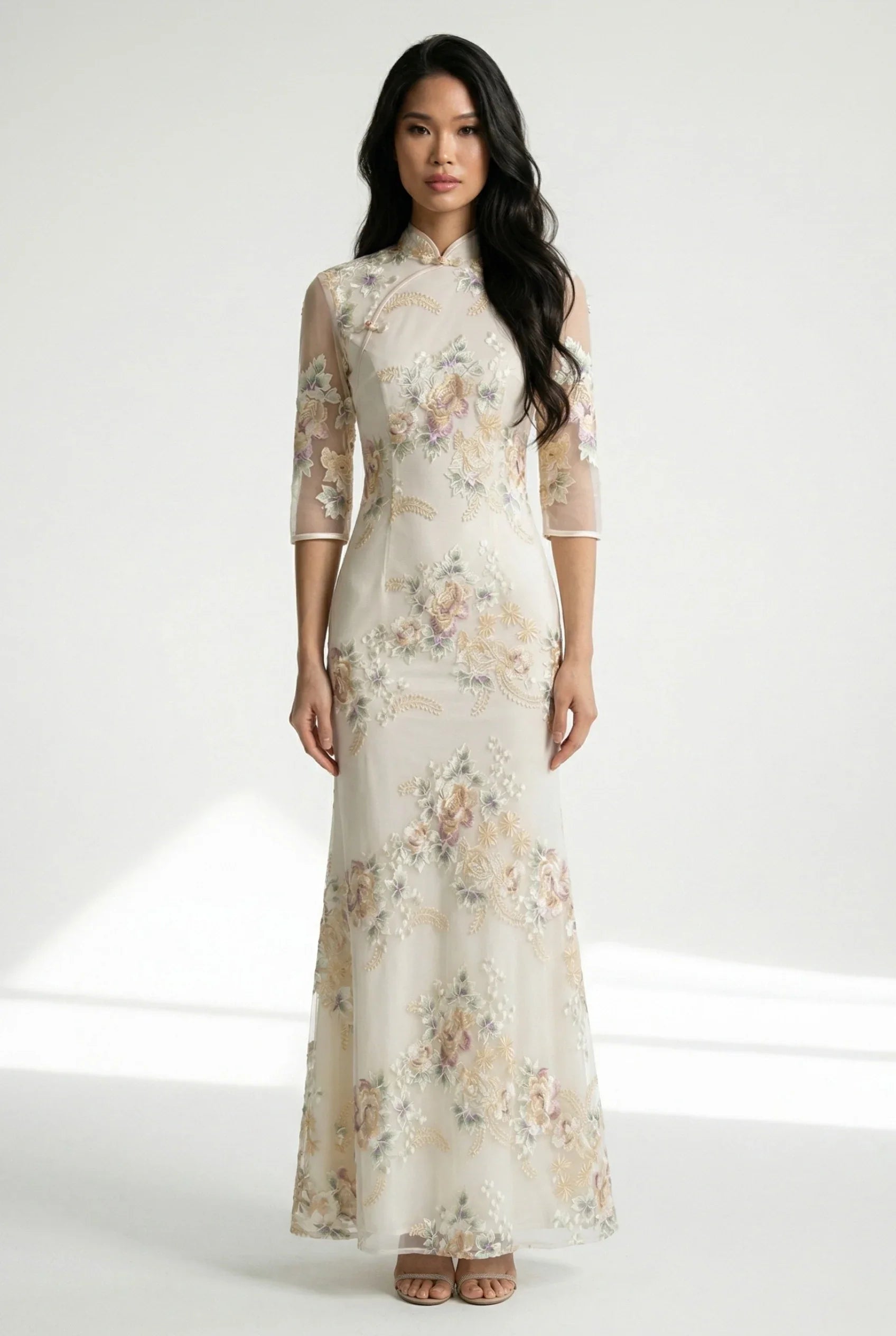 Front full view of a beige Chinese dress with floral embroidery.