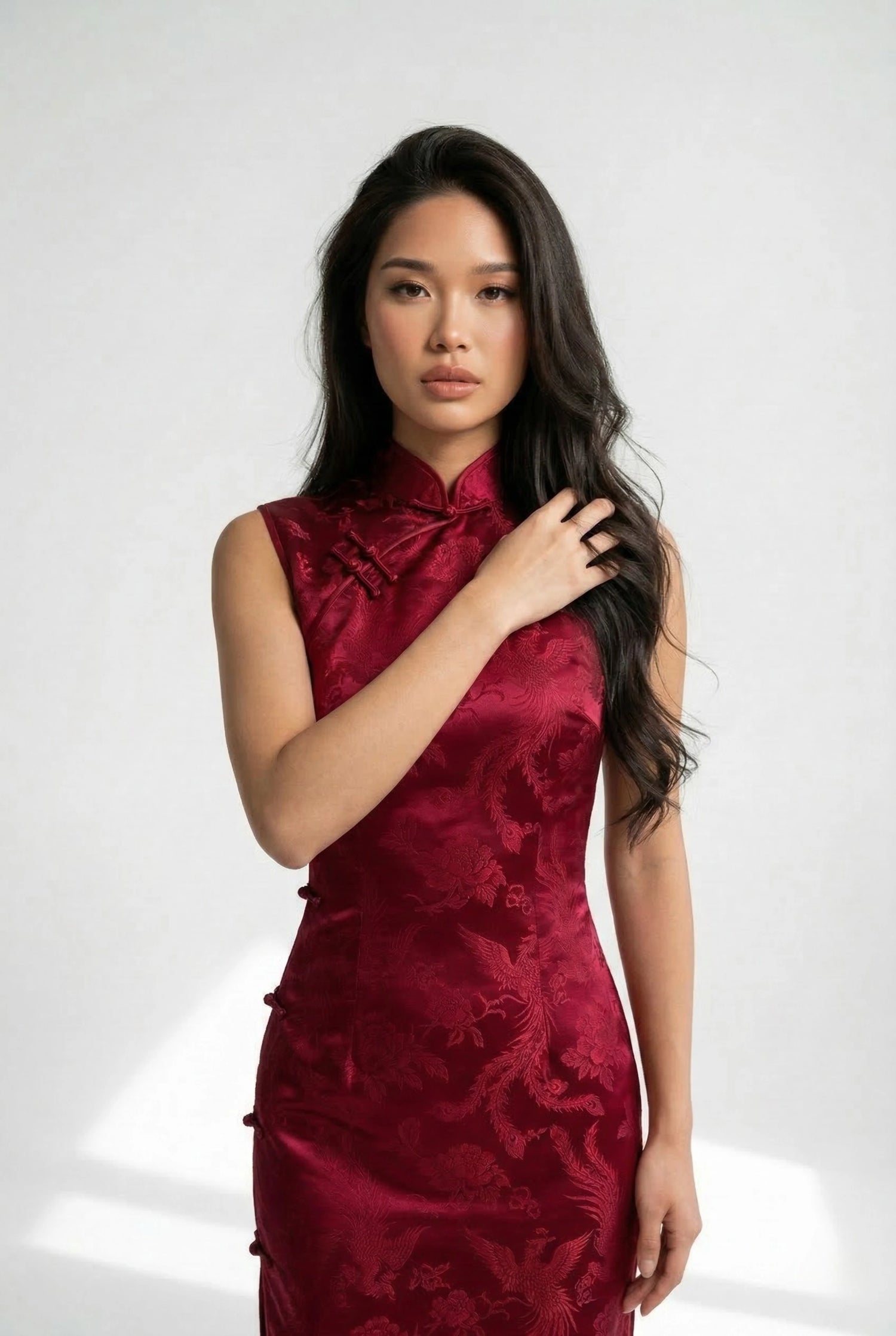 Expert guide on sizing and maintenance of an authentic red Chinese qipao, demonstrating the Two-Finger Rule for a perfect Mandarin collar fit