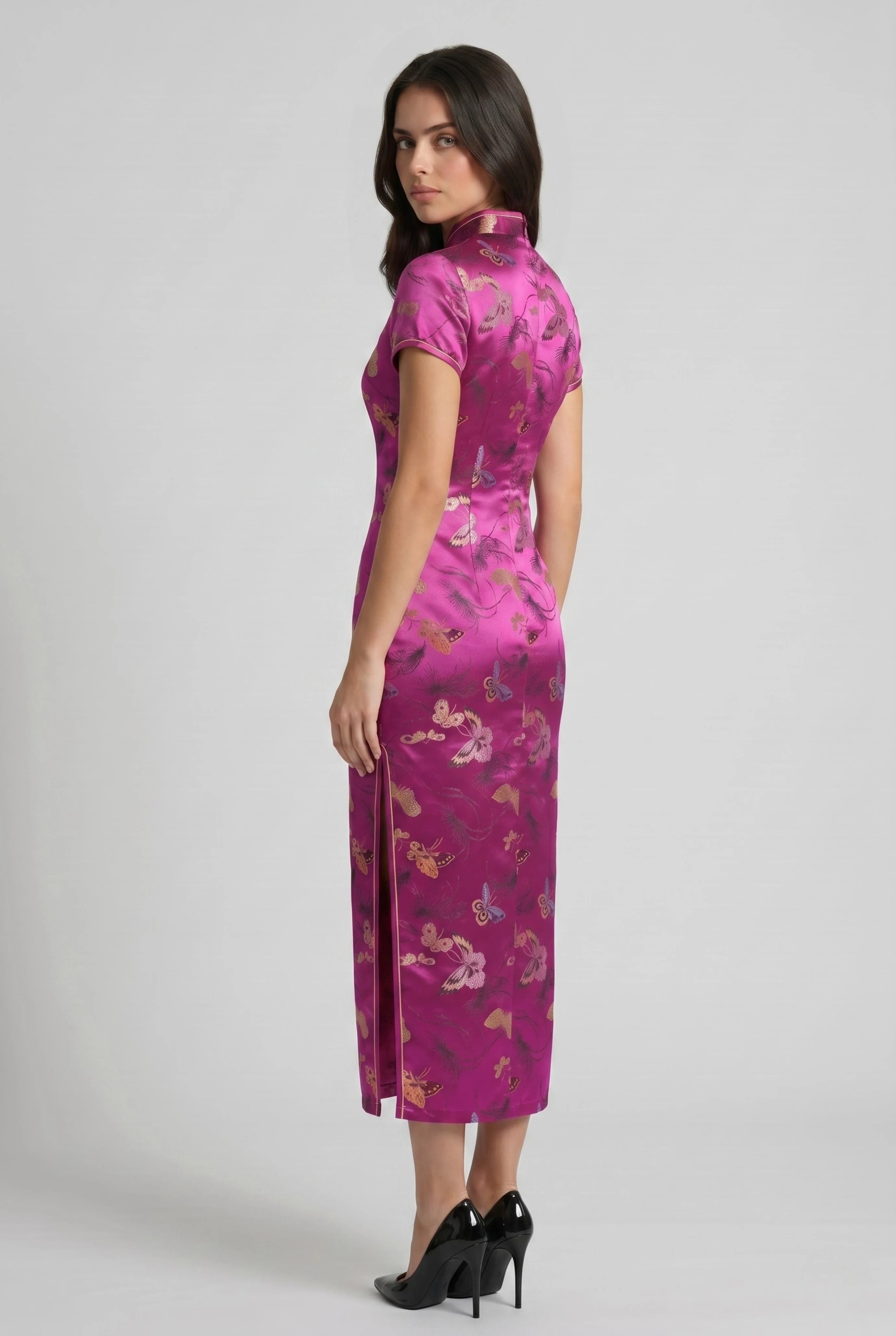 Three-quarter back profile view highlighting the tailored fit and side slit of the fuchsia pink cheongsam dress