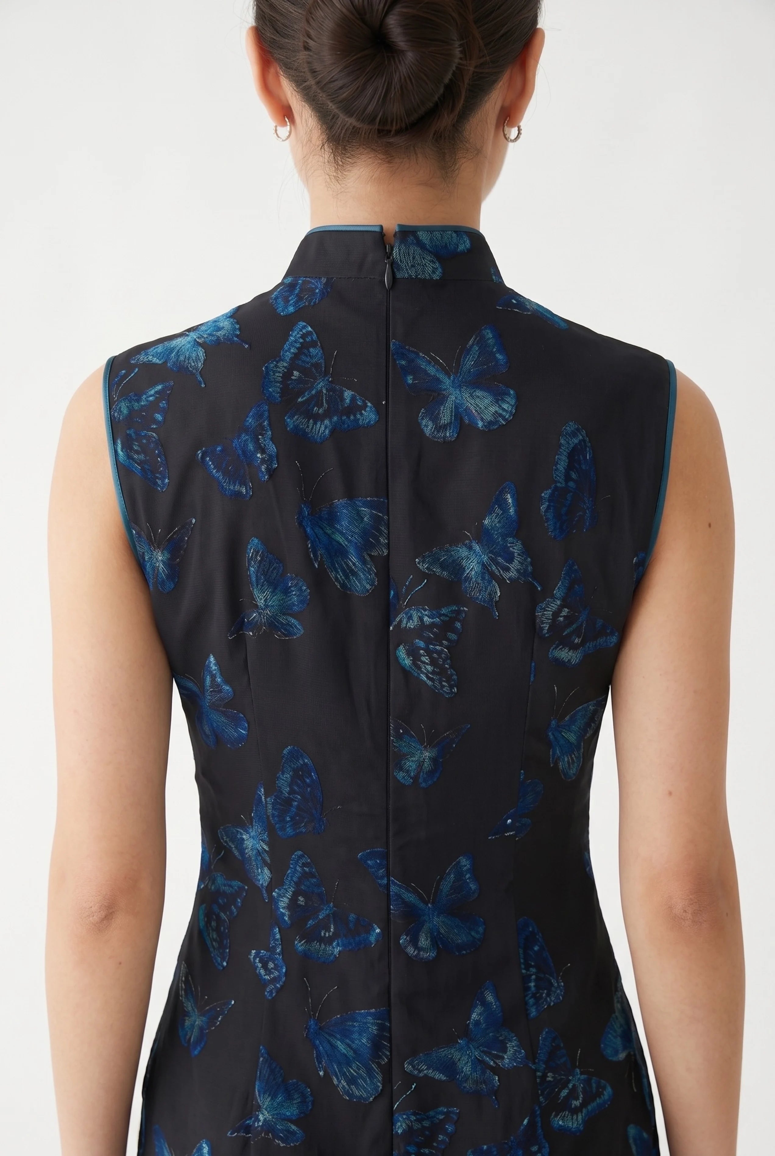 Close-up back view showing the precise zipper closure and the detailed butterfly jacquard pattern on the collar