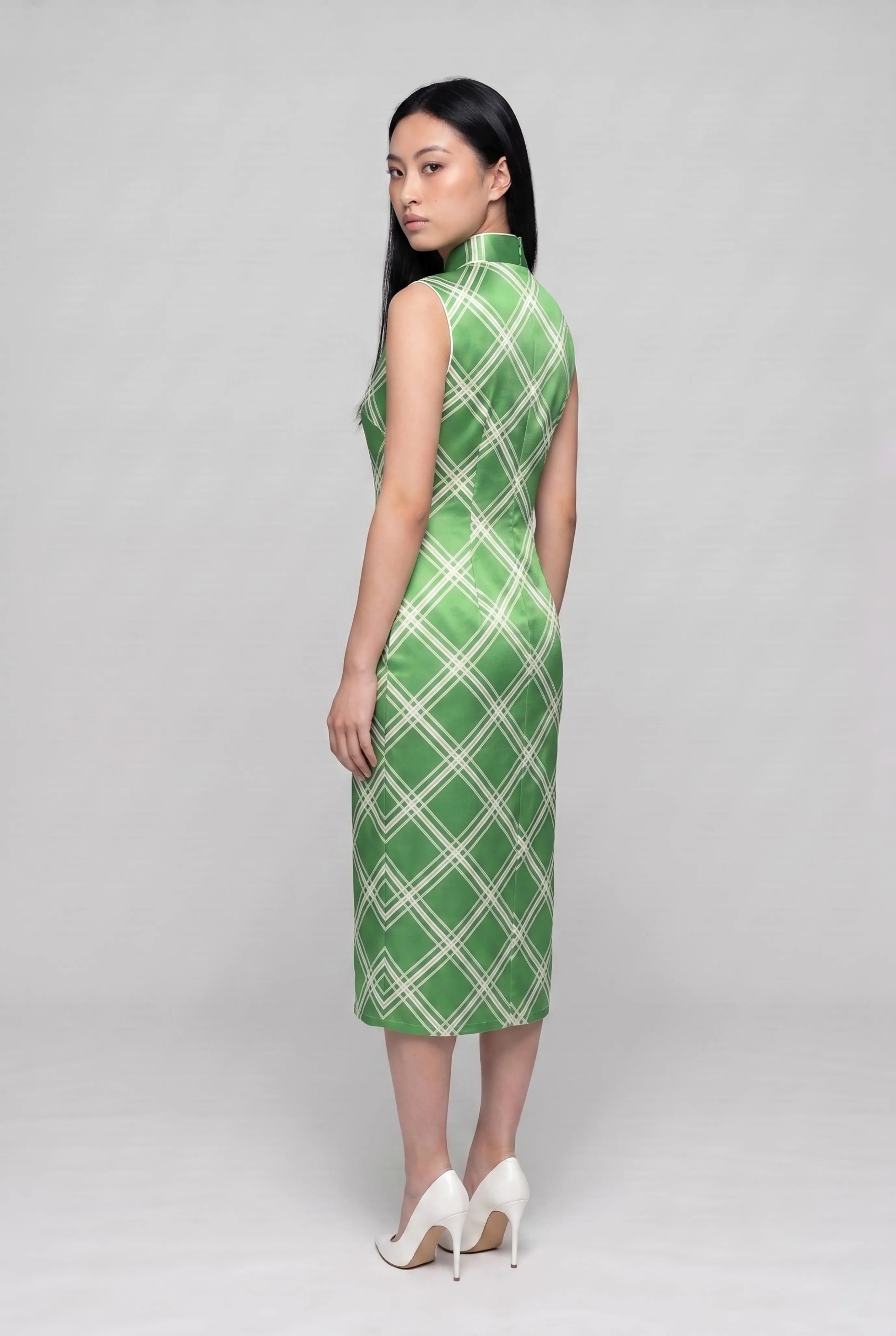 Three-quarter back profile view highlighting the form-fitting design of the lime green satin cheongsam dress