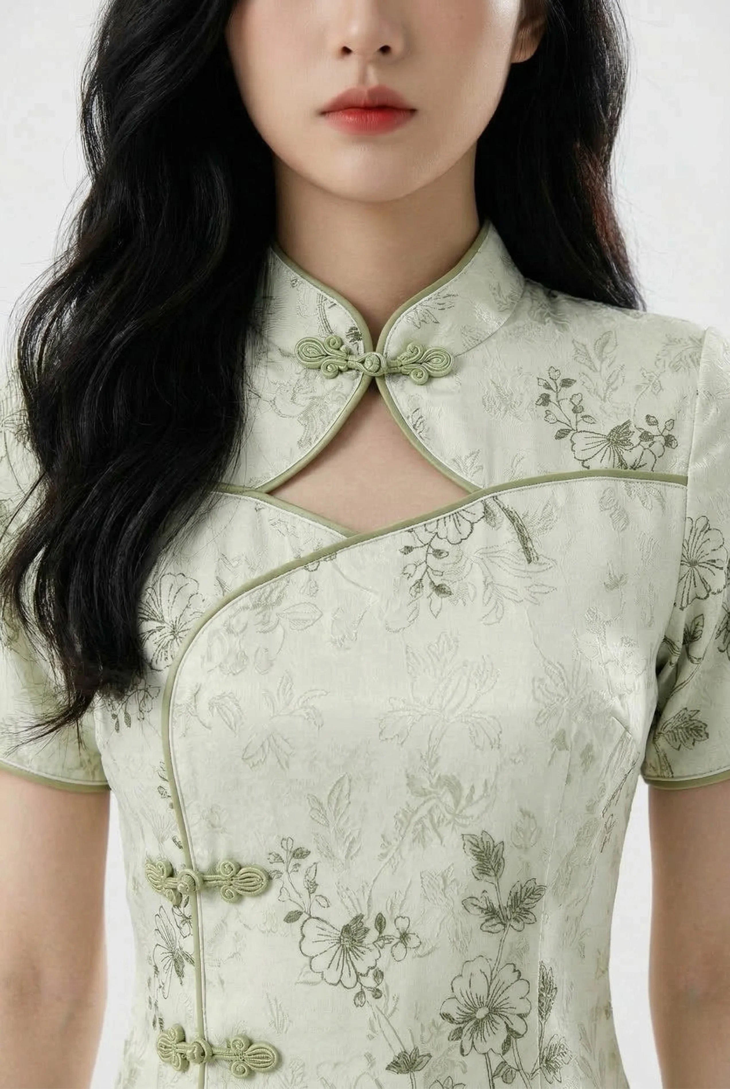 Close-up of the keyhole neckline and mandarin collar on the green qipao.