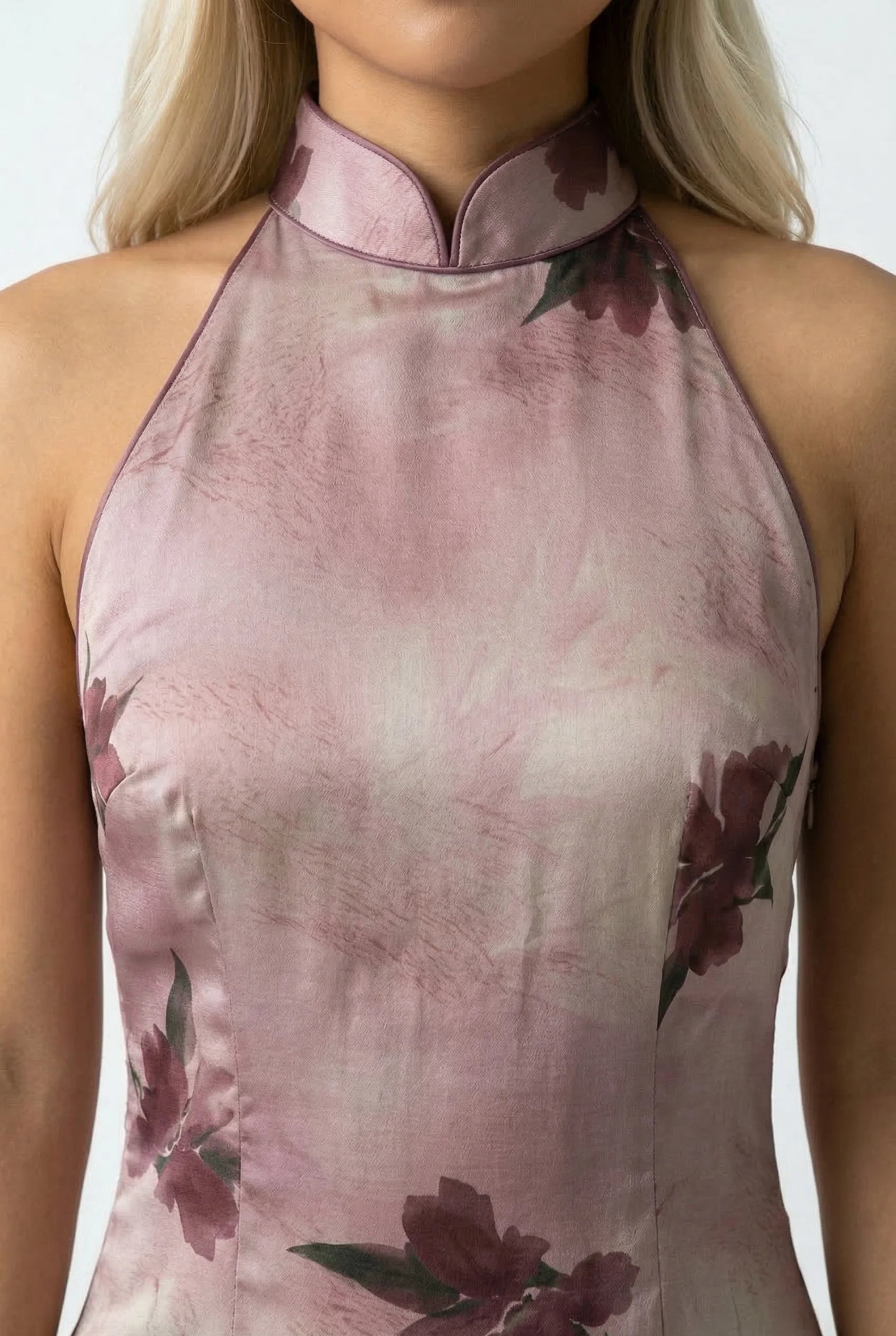 Close-up detail of the halter-style mandarin collar and the silk-like floral fabric of a Maison Hua dress.