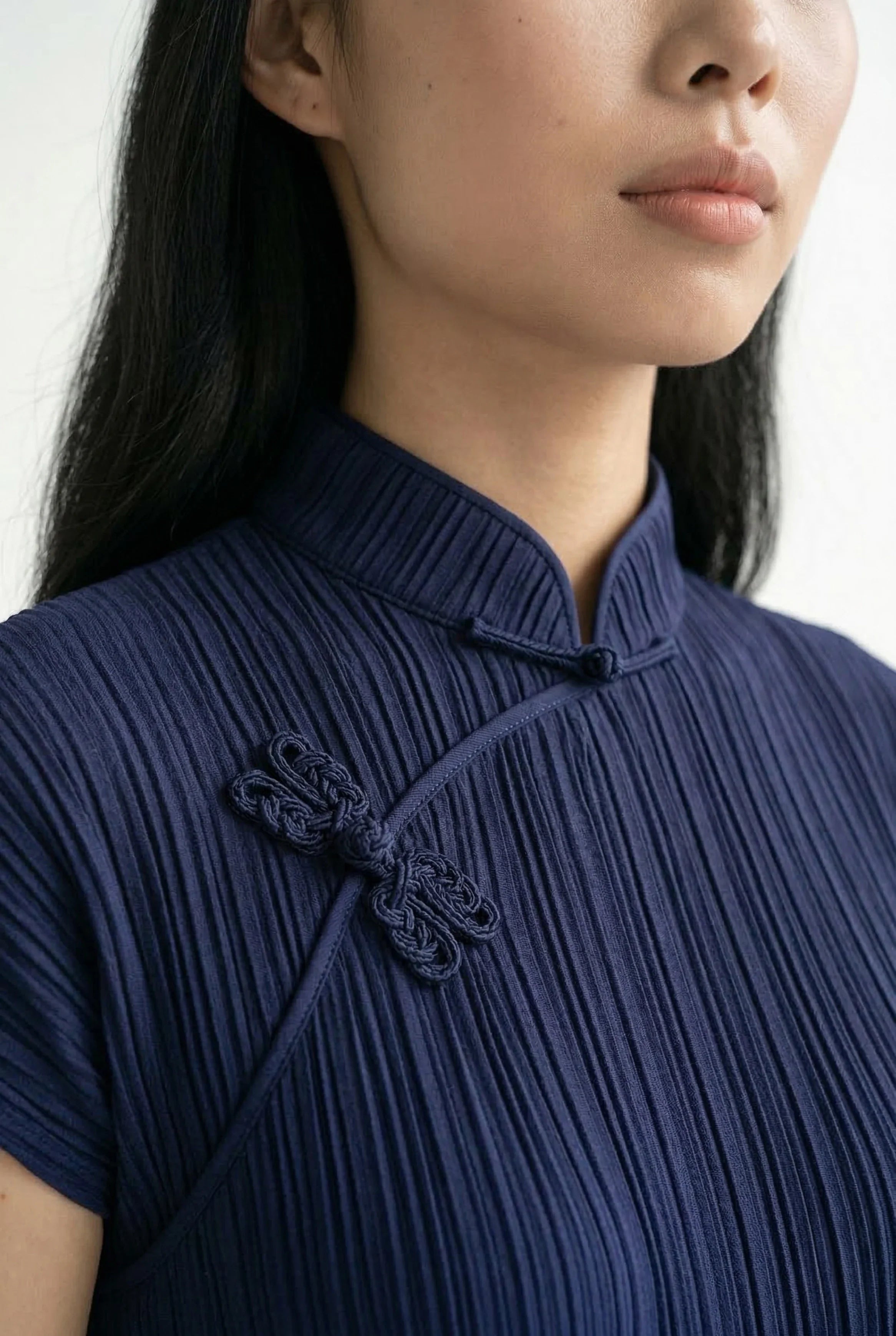 Detailed shot of the high back collar and halter design on a purple Chinese dress.