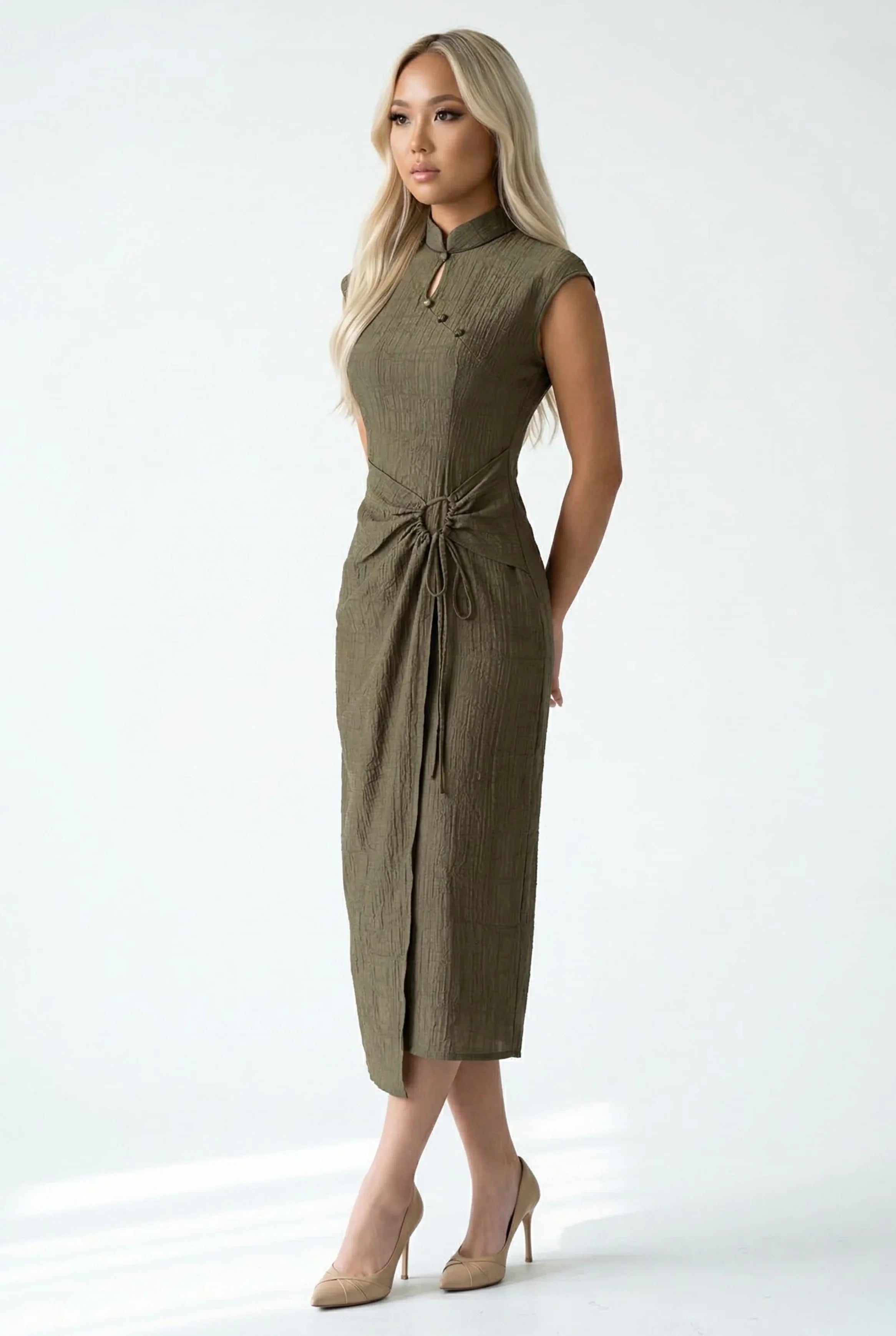 Side view of a khaki textured Cheongsam dress highlighting the elegant wrap-style drape detail at the waist.