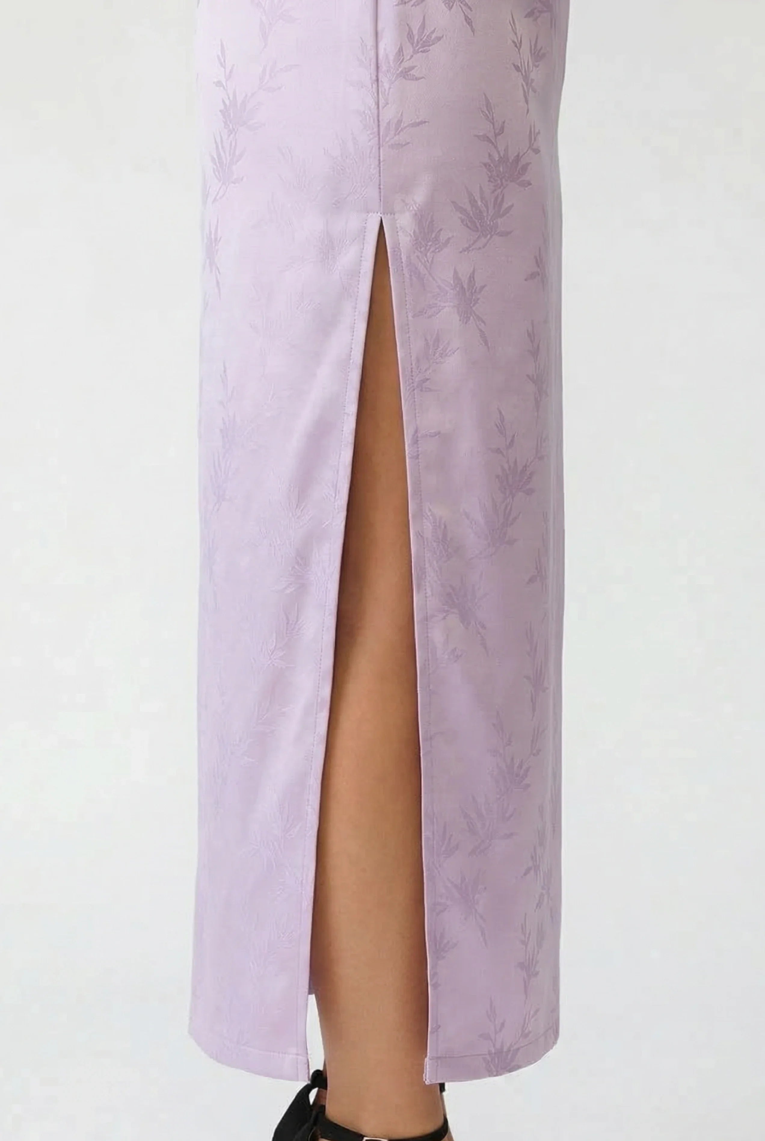 Close-up of the elegant high side slit on a lavender Cheongsam dress, showing the fabric texture and movement.