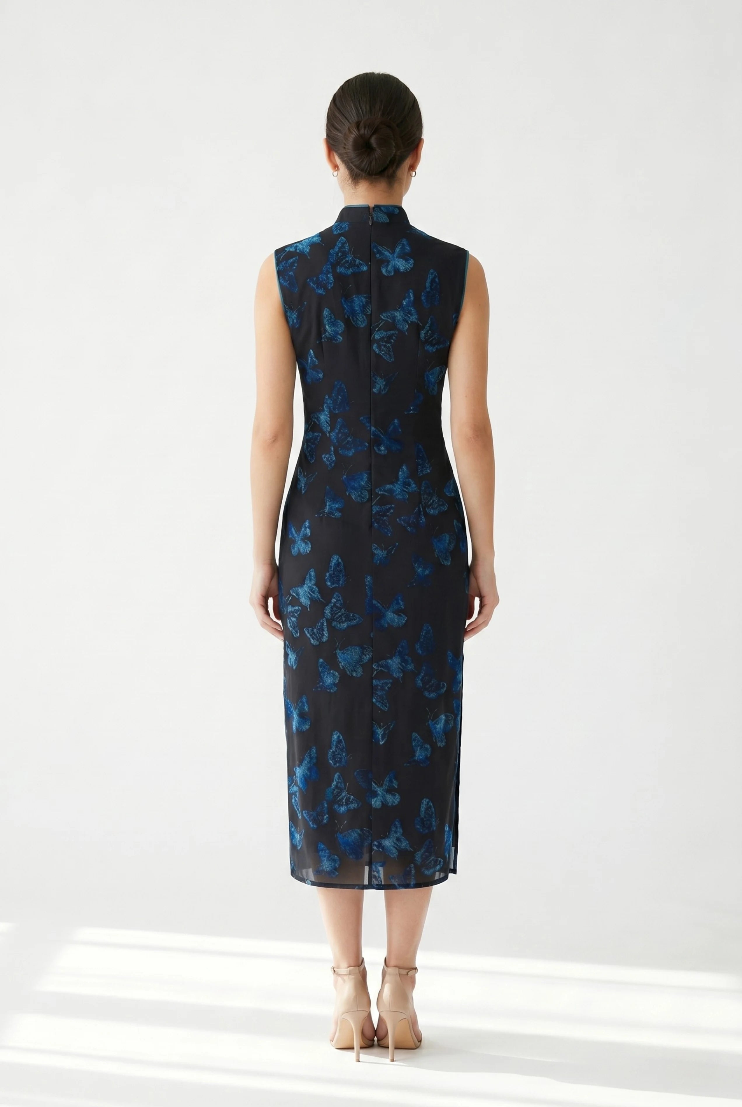 Full-length back view of the light green Chinese dress showing the clean, form-fitting design