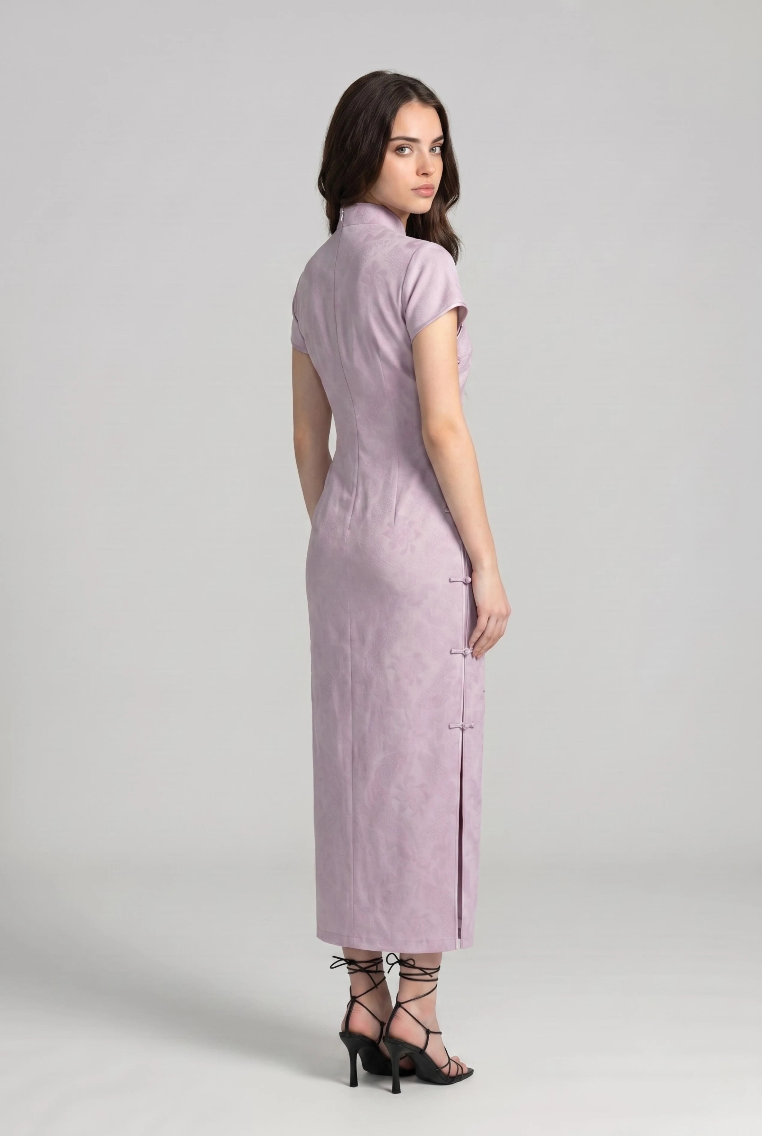 Three-quarter back profile view highlighting the form-fitting design of the light purple cheongsam dress