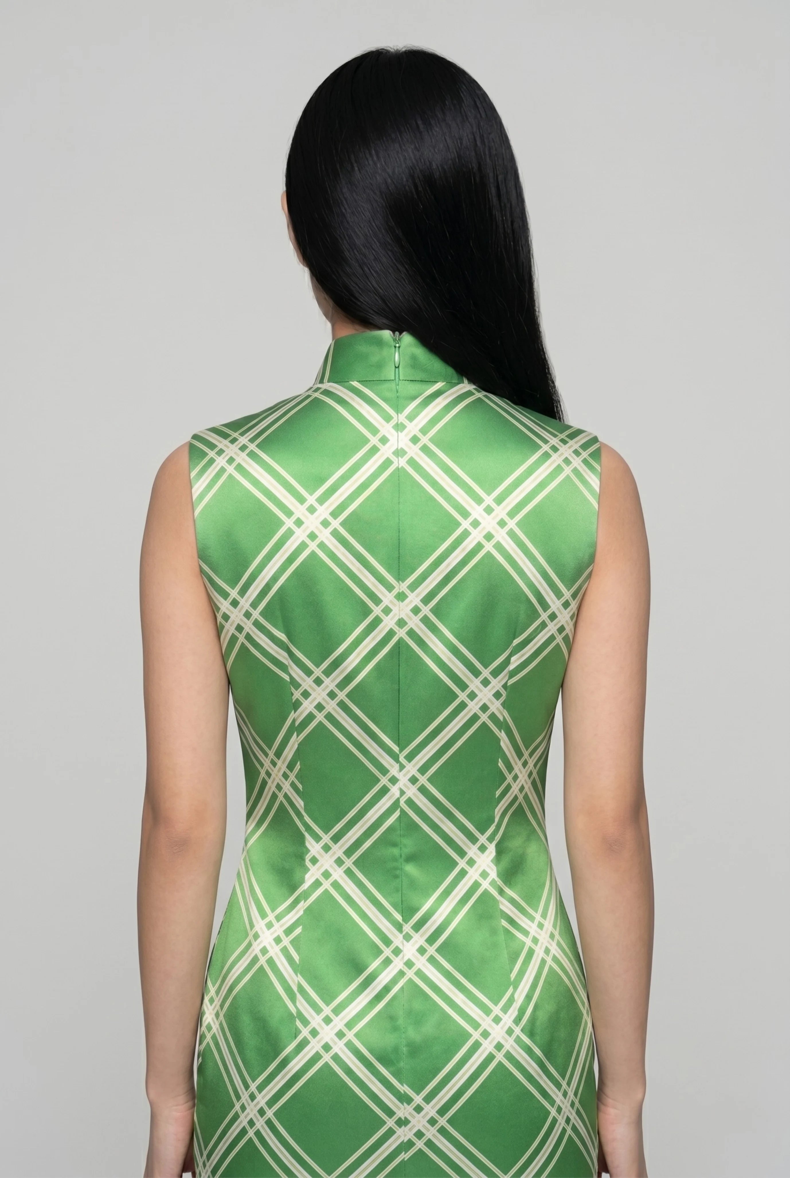 Close-up back view showing the precise zipper closure and structured high collar of the lime green diamond cheongsam
