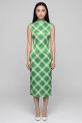 Front full-length view of a sleeveless lime green diamond qipao dress with a high mandarin collar and white heels