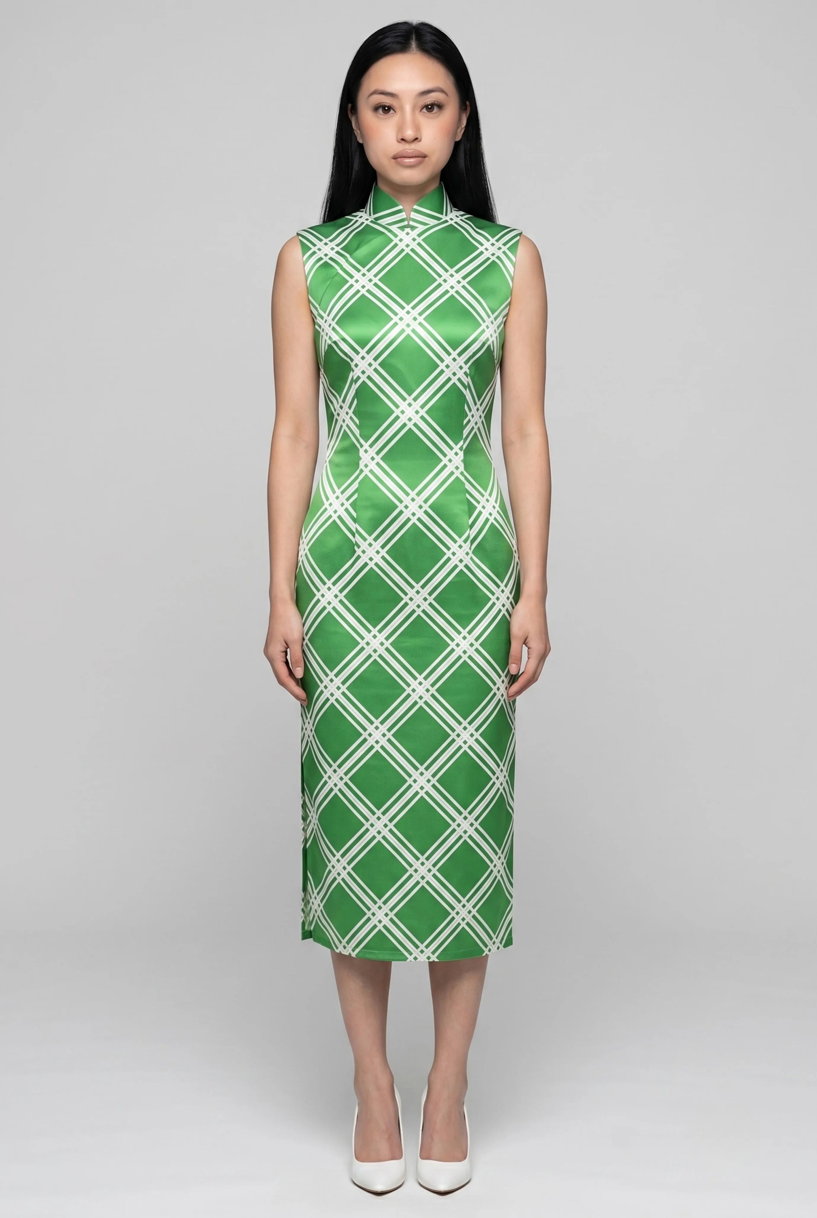 Front full-length view of a sleeveless lime green diamond qipao dress with a high mandarin collar and white heels
