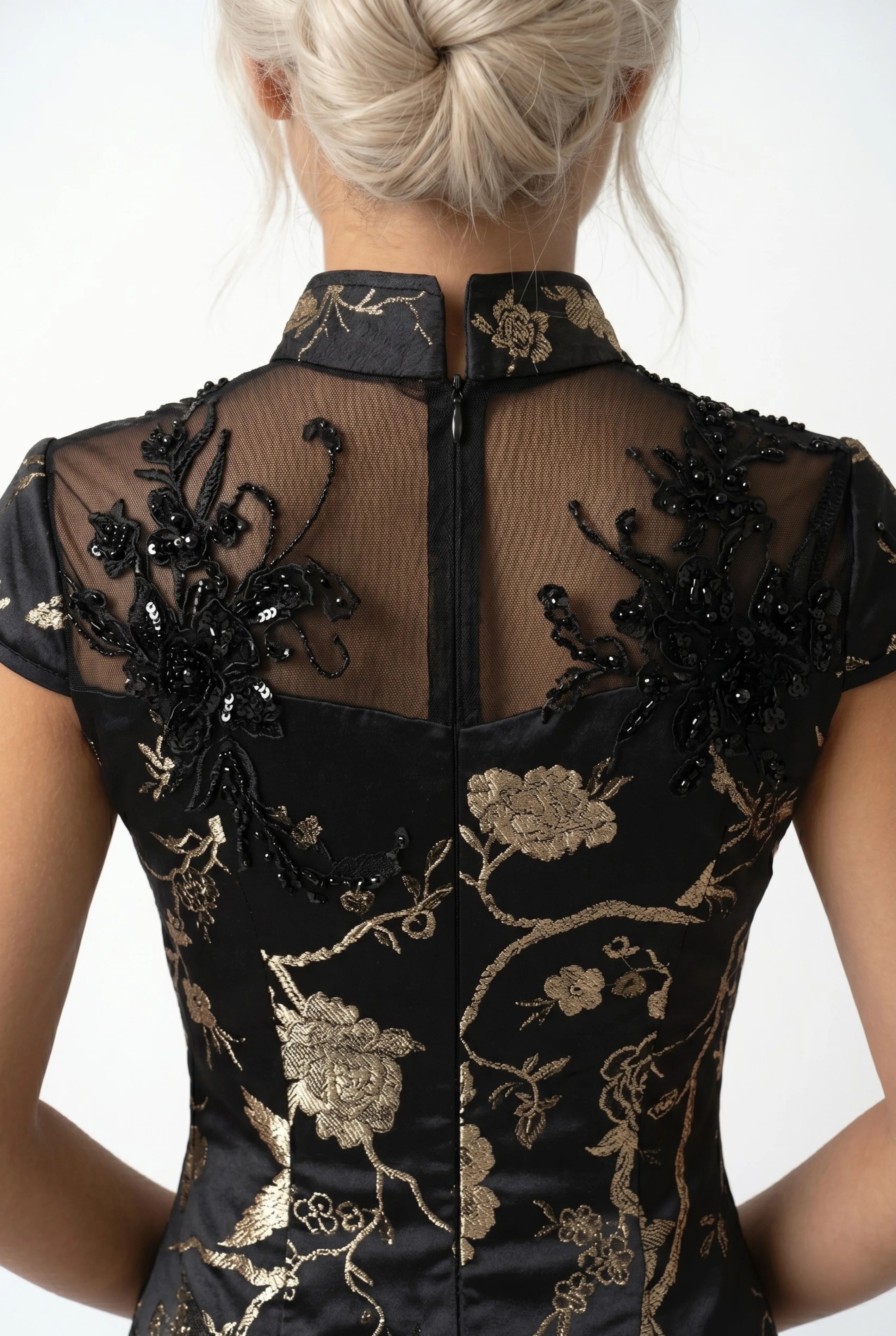 Close-up back view showing the sheer mesh panel, intricate black beading, and rear zipper closure