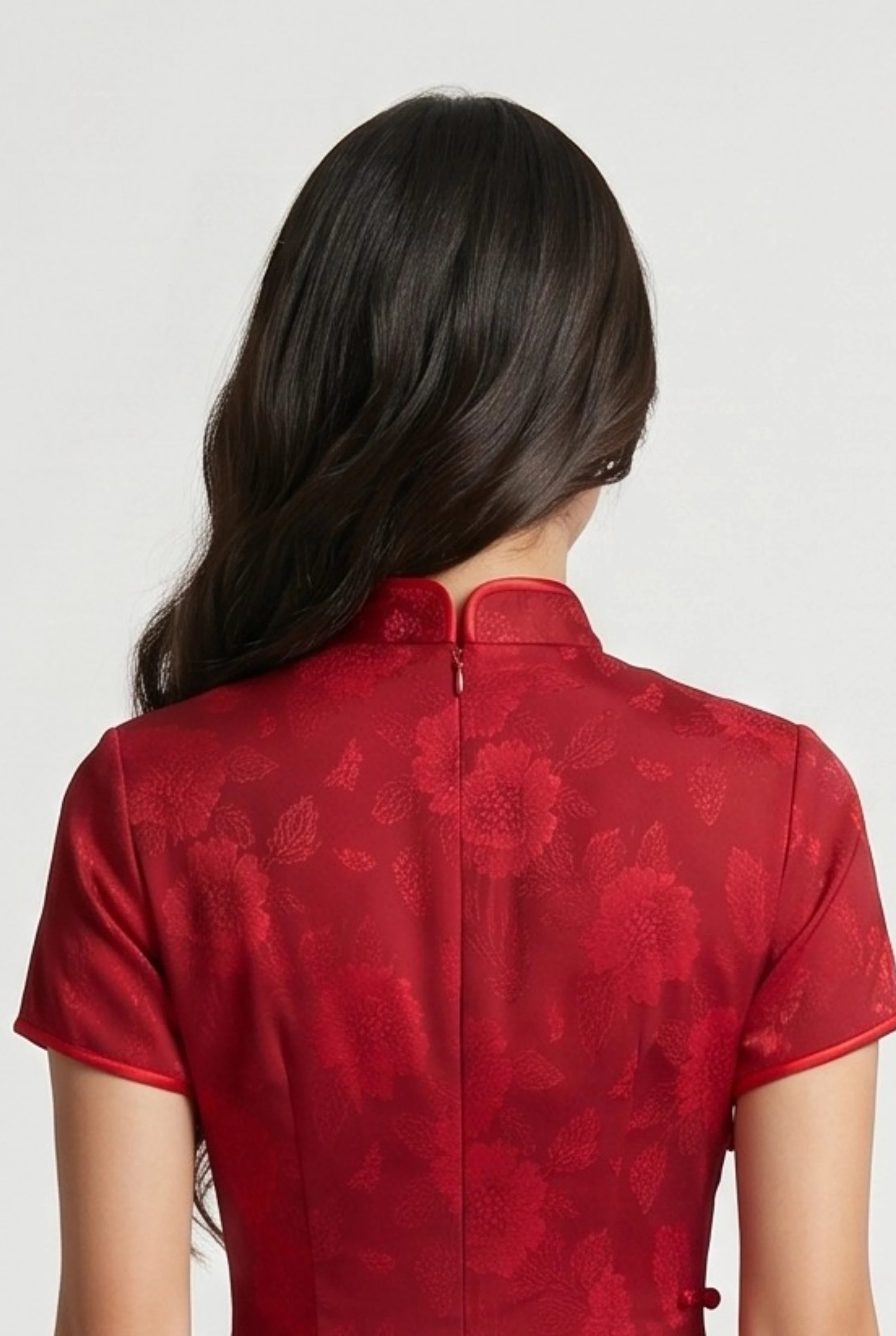 Close-up back view showing the hidden zipper closure and high collar structure of the long red cheongsam